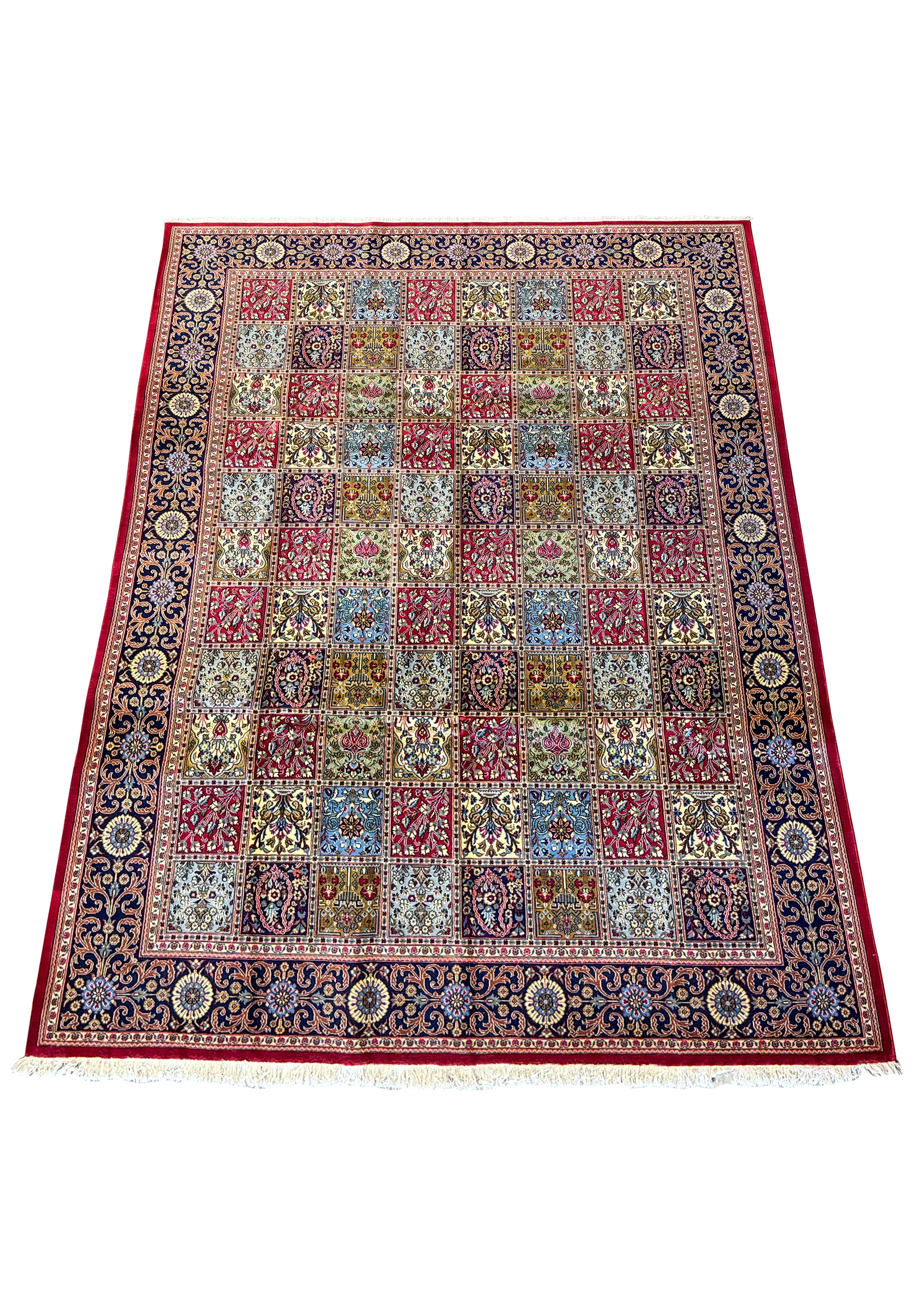 Overhead full shot of an 8 x 11'3 luxury Persian Qum Kork rug displaying a grid of ornate floral patterns and a richly decorated navy border
