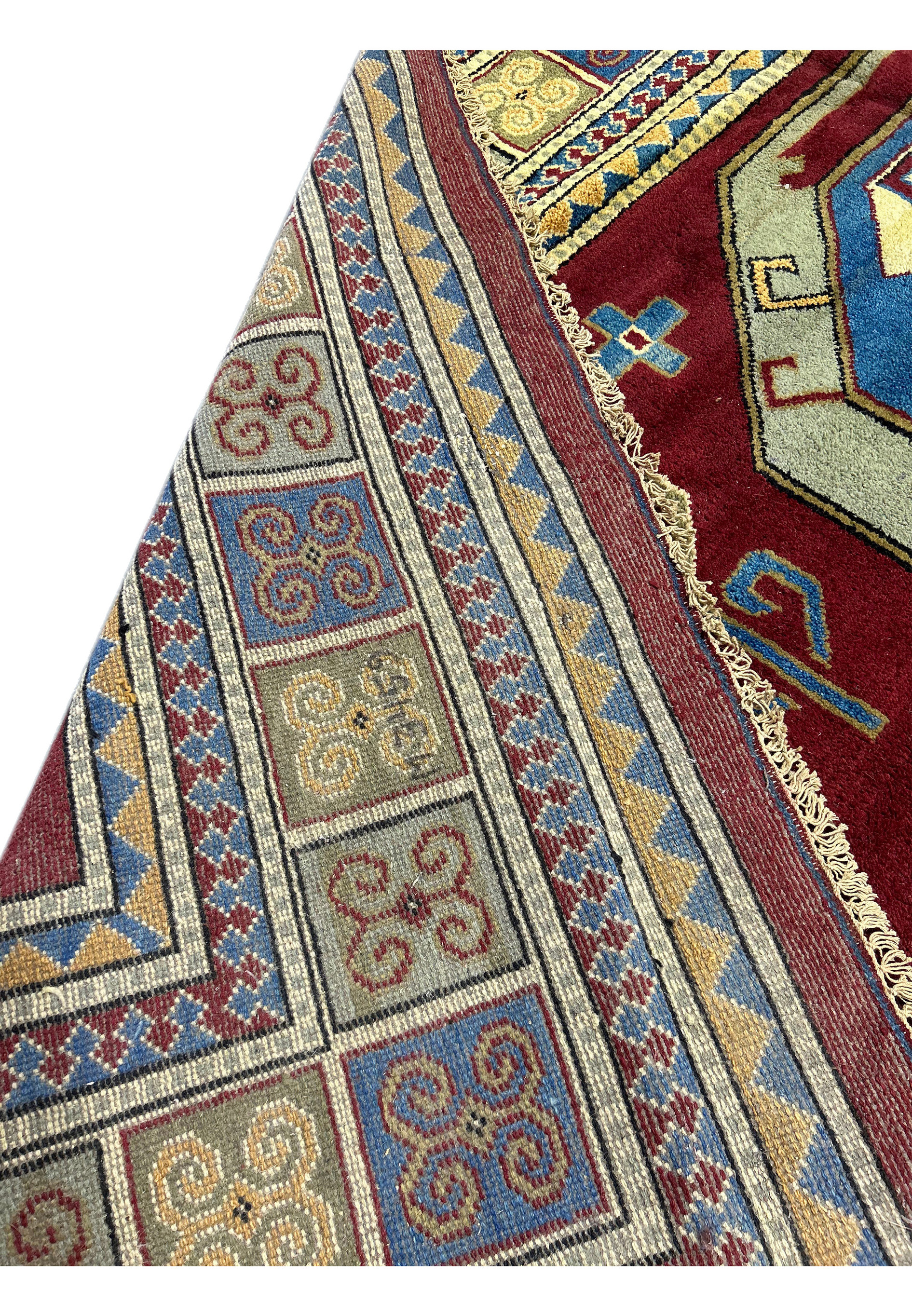 An extreme close-up showing the density and quality of the weave. The focus is on the colorful threads and the tightness of the knots.