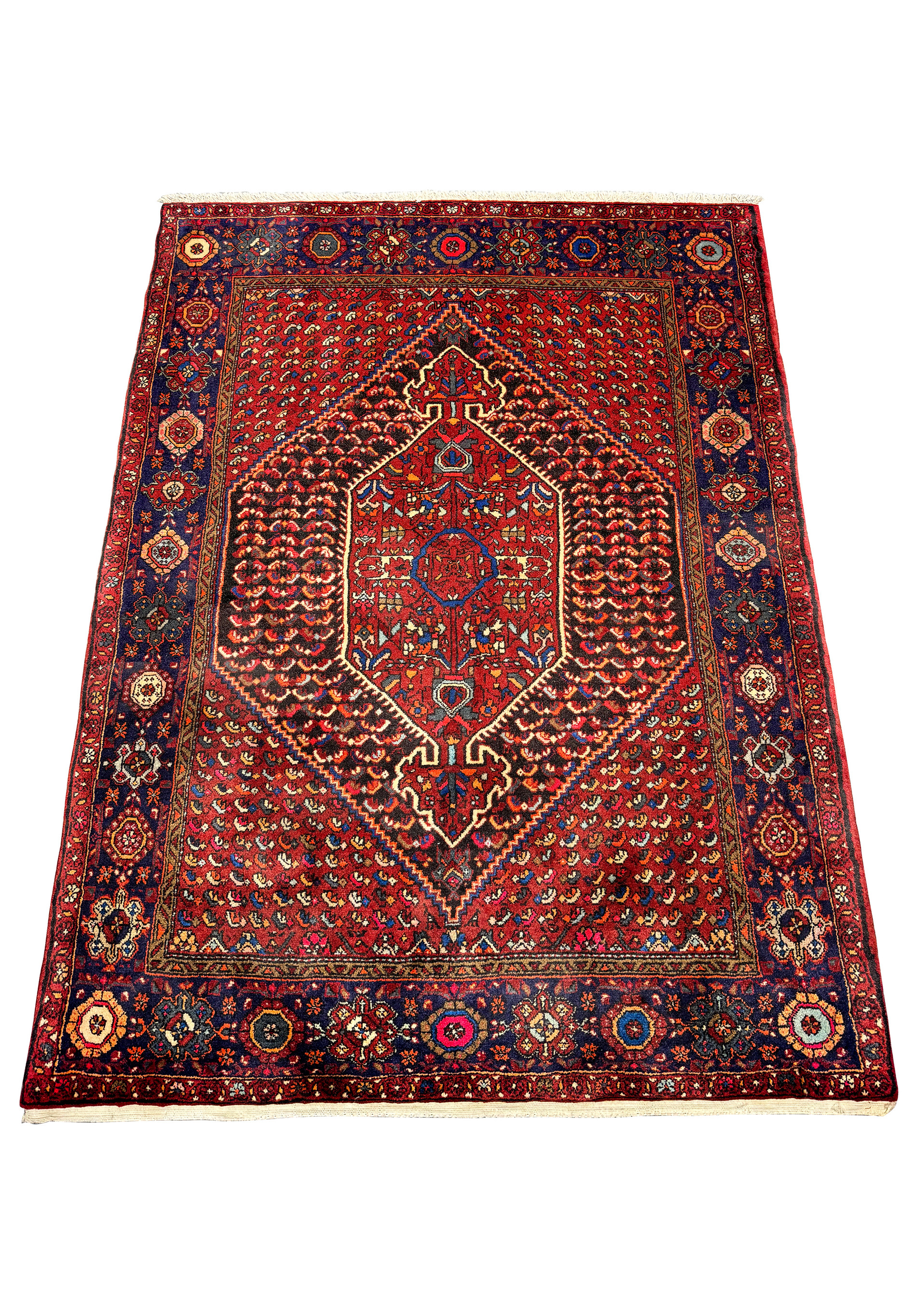 Full view of a Persian Gholtogh rug, displaying a complex design with a red central medallion, surrounded by dark blue borders featuring detailed floral and geometric motifs in multicolors