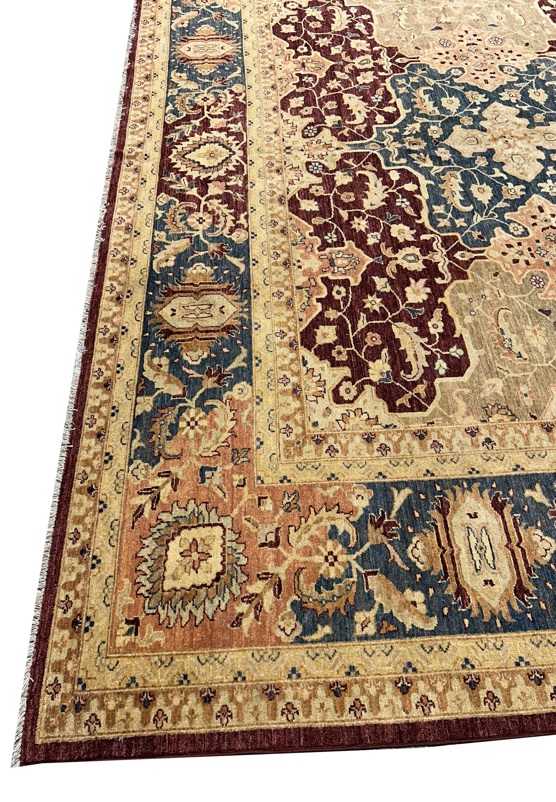 Detailed view of the Agra rug's central design, showcasing the intricate floral motifs and the rich vegetable-dyed colors. The natural wool fibers provide a soft and durable texture.