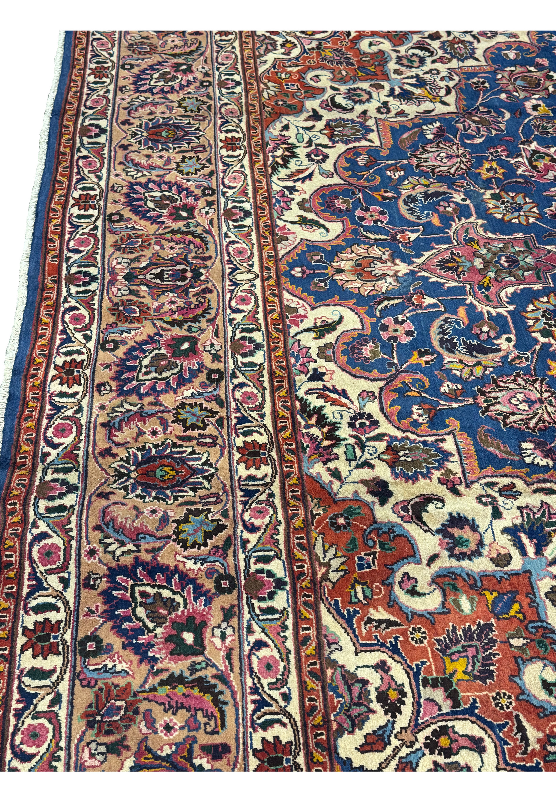 Close-up of the border detail on a Mashad Persian Rug, featuring vibrant colors and intricate floral patterns.