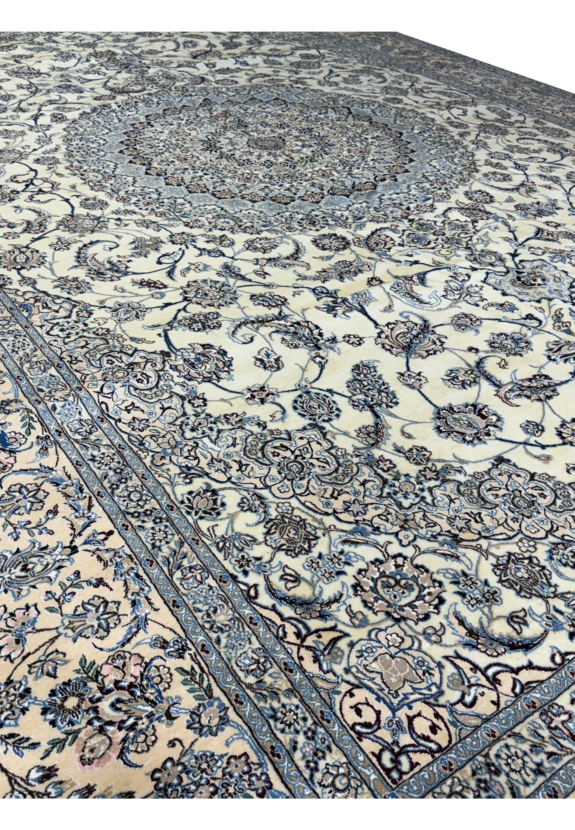 Close-up of the corner section showing intricate floral patterns and border of a Persian Nain 9LAA Wool & Silk Rug.