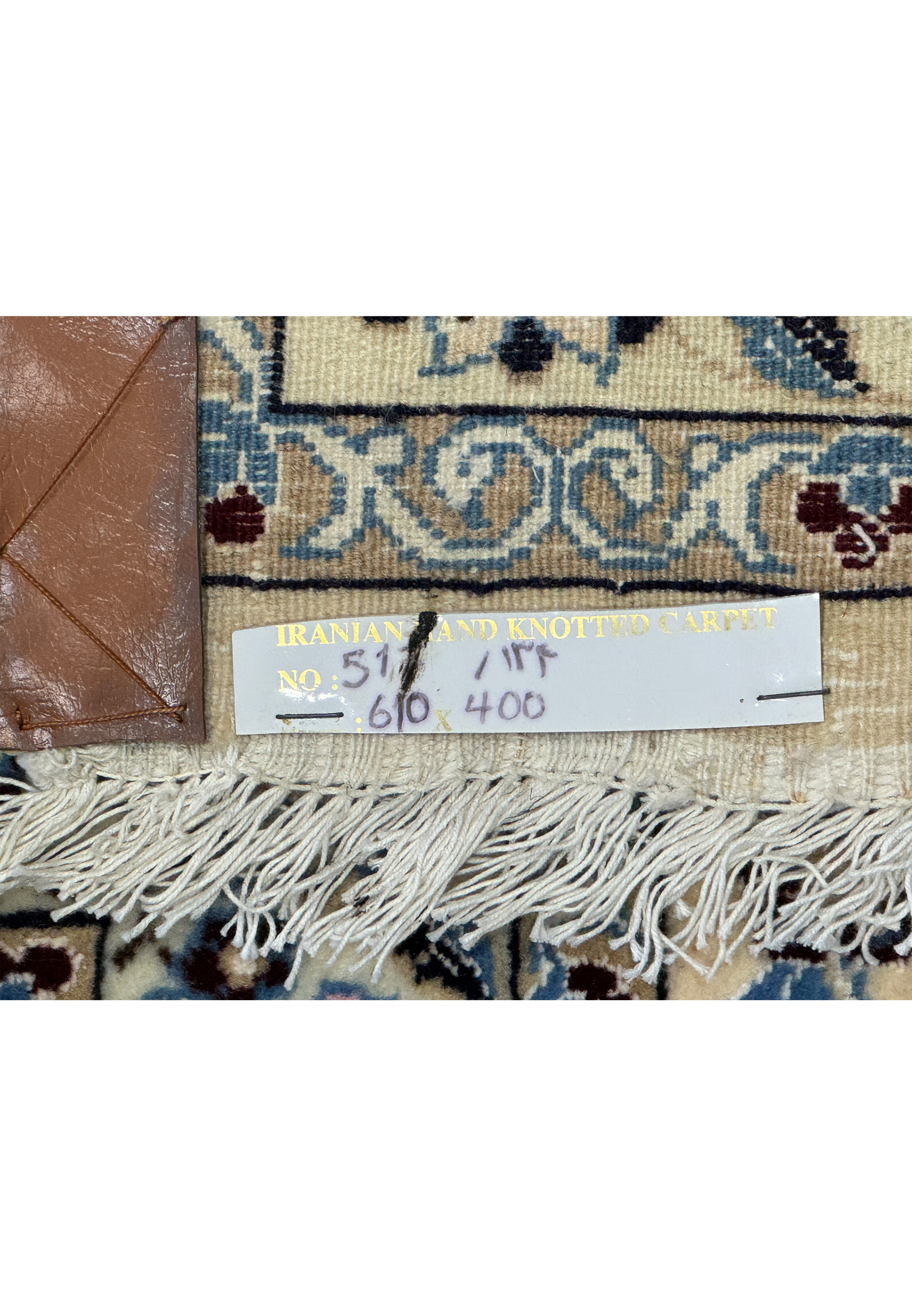 Label close-up on the Persian Nain 9LAA Wool & Silk Rug indicating its size and origin.
