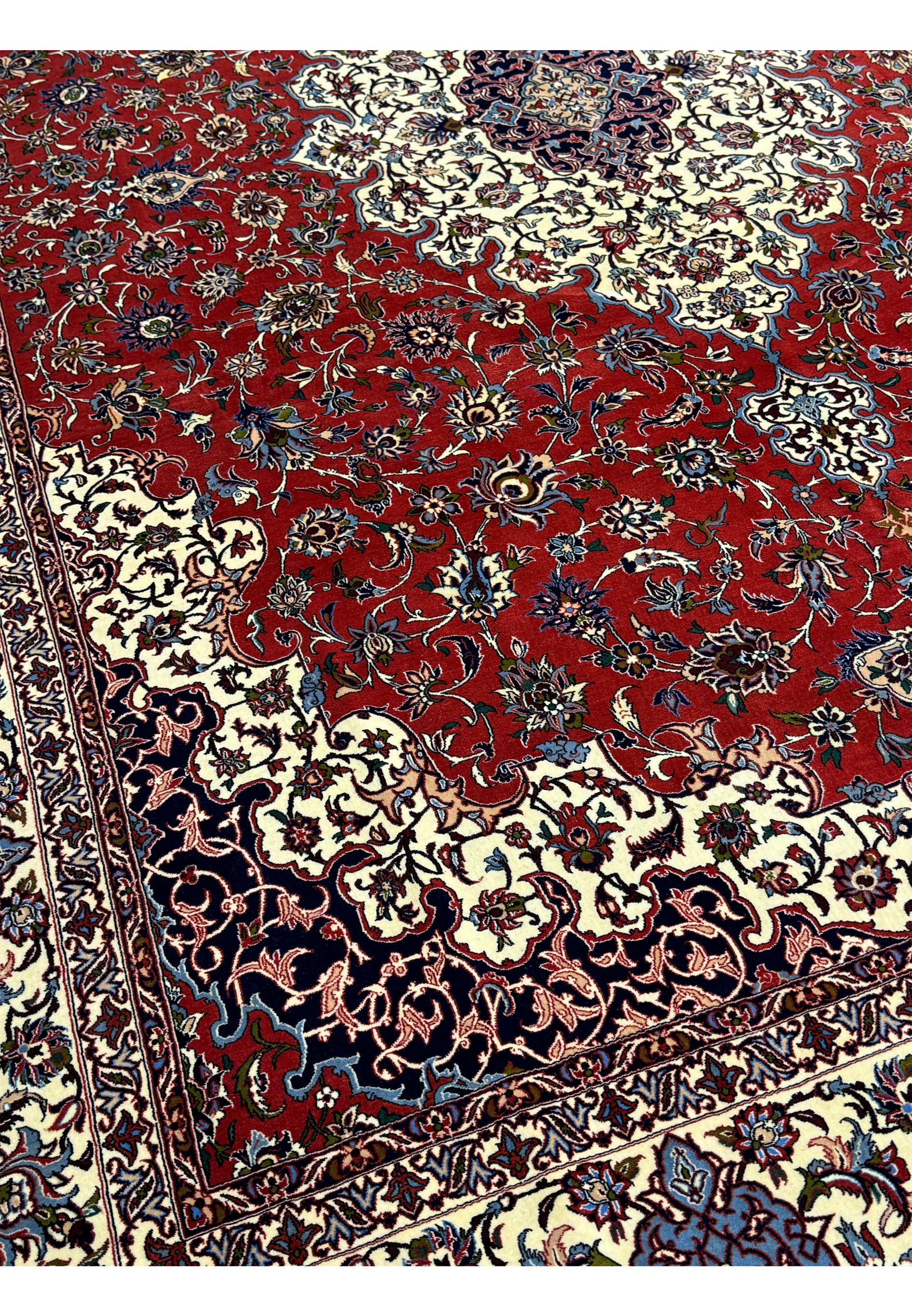 Close-up of floral motifs and vibrant red background in Persian Isfahan Silk Rug.