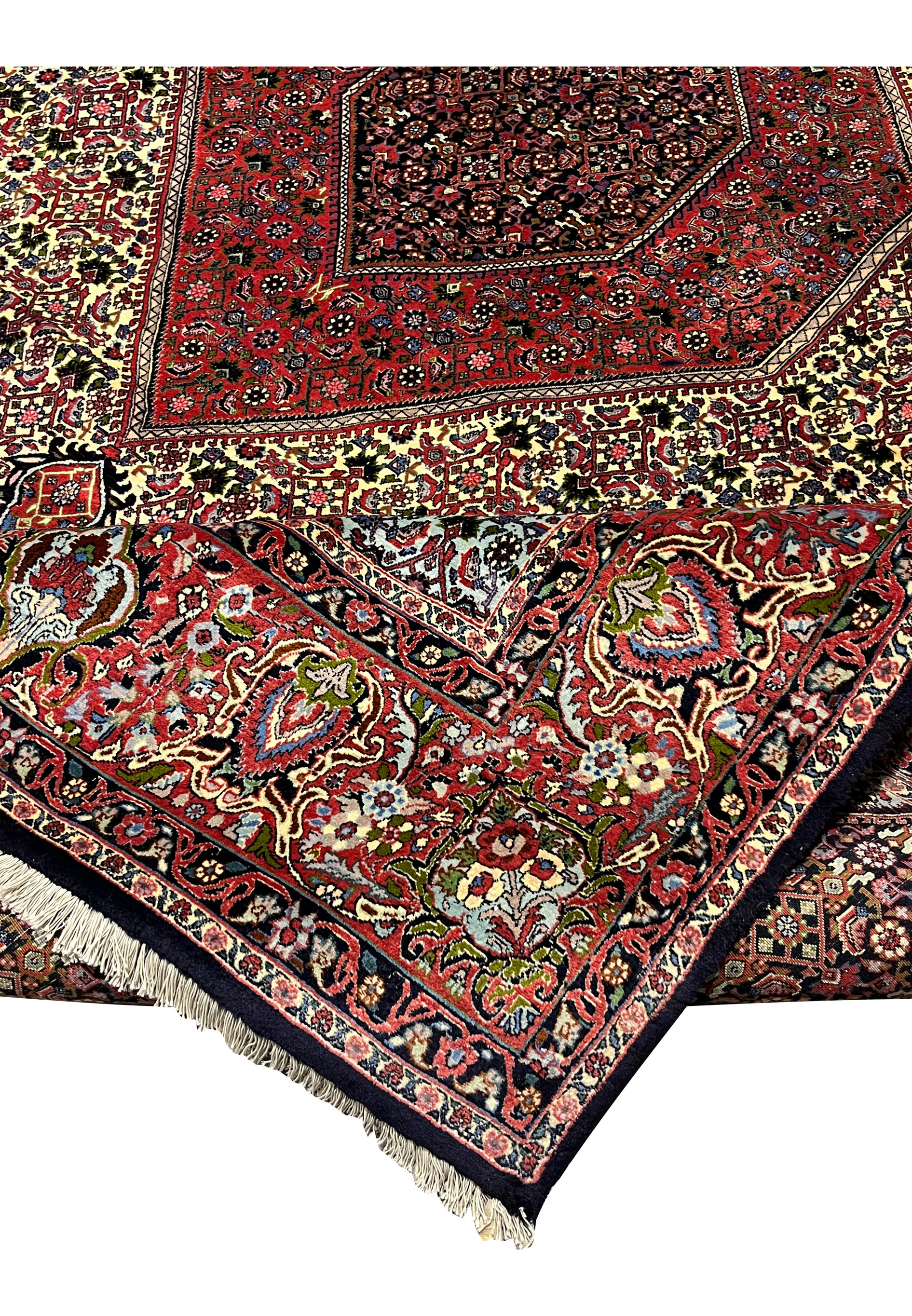 Folded corner of a Persian Bijar rug highlighting its substantial weight, dense wool foundation, crisp pattern alignment, and exceptional durability.