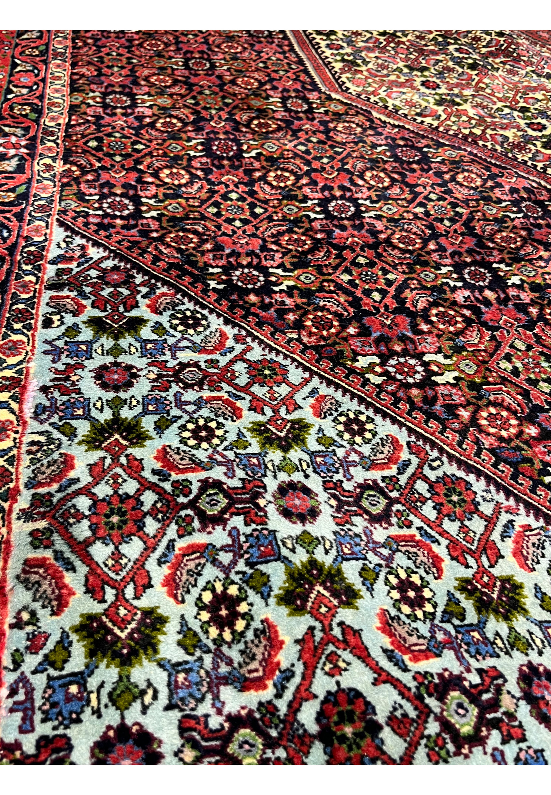 Inner border close-up of a 9.8 x 12.2 Persian Bijar rug displaying fine floral patterns, contrasting ivory and red tones, and tightly packed hand-knotted details.