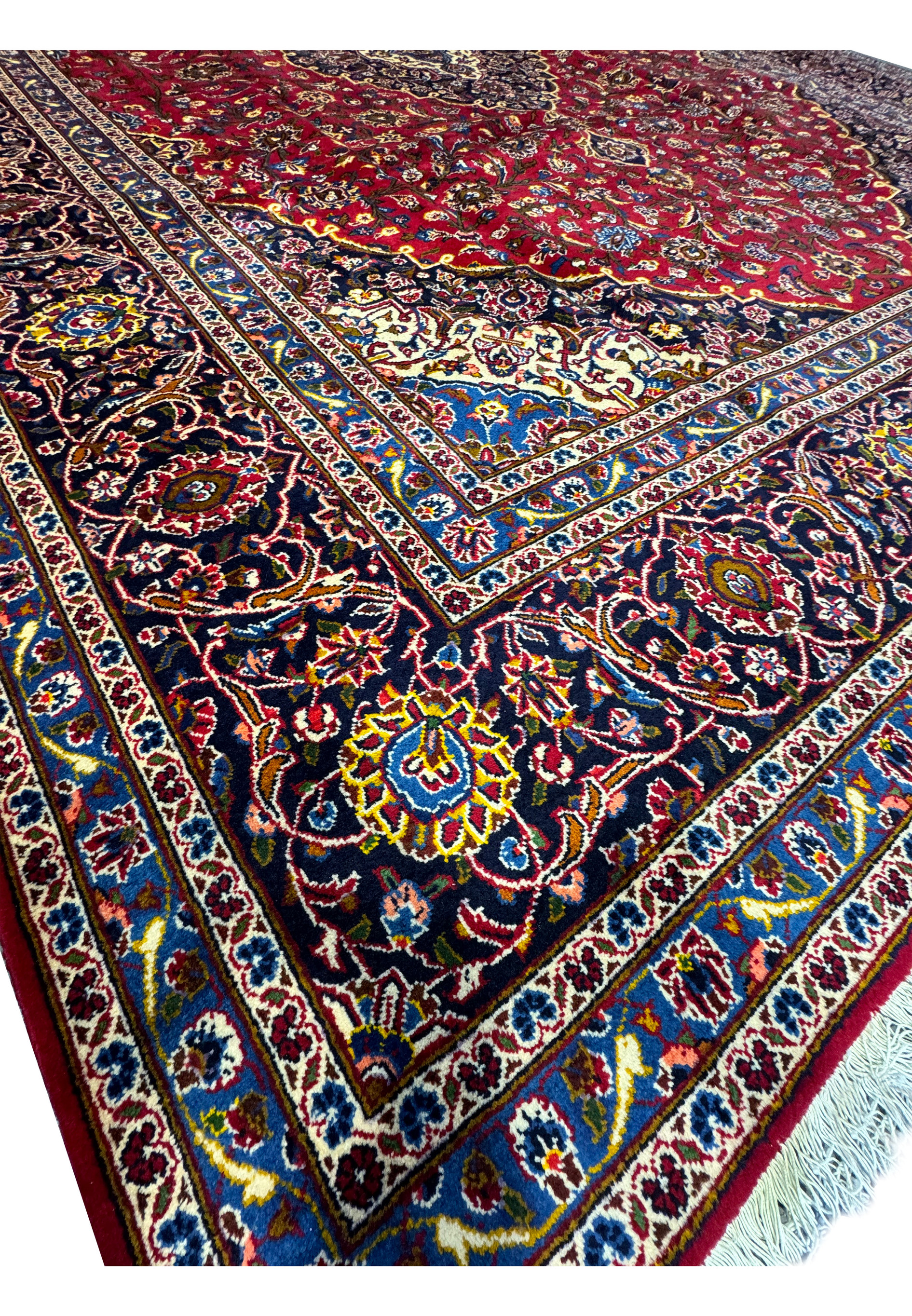 Close-up view of the corner of the Persian Kashan Rug, showcasing the fine details and color contrasts.