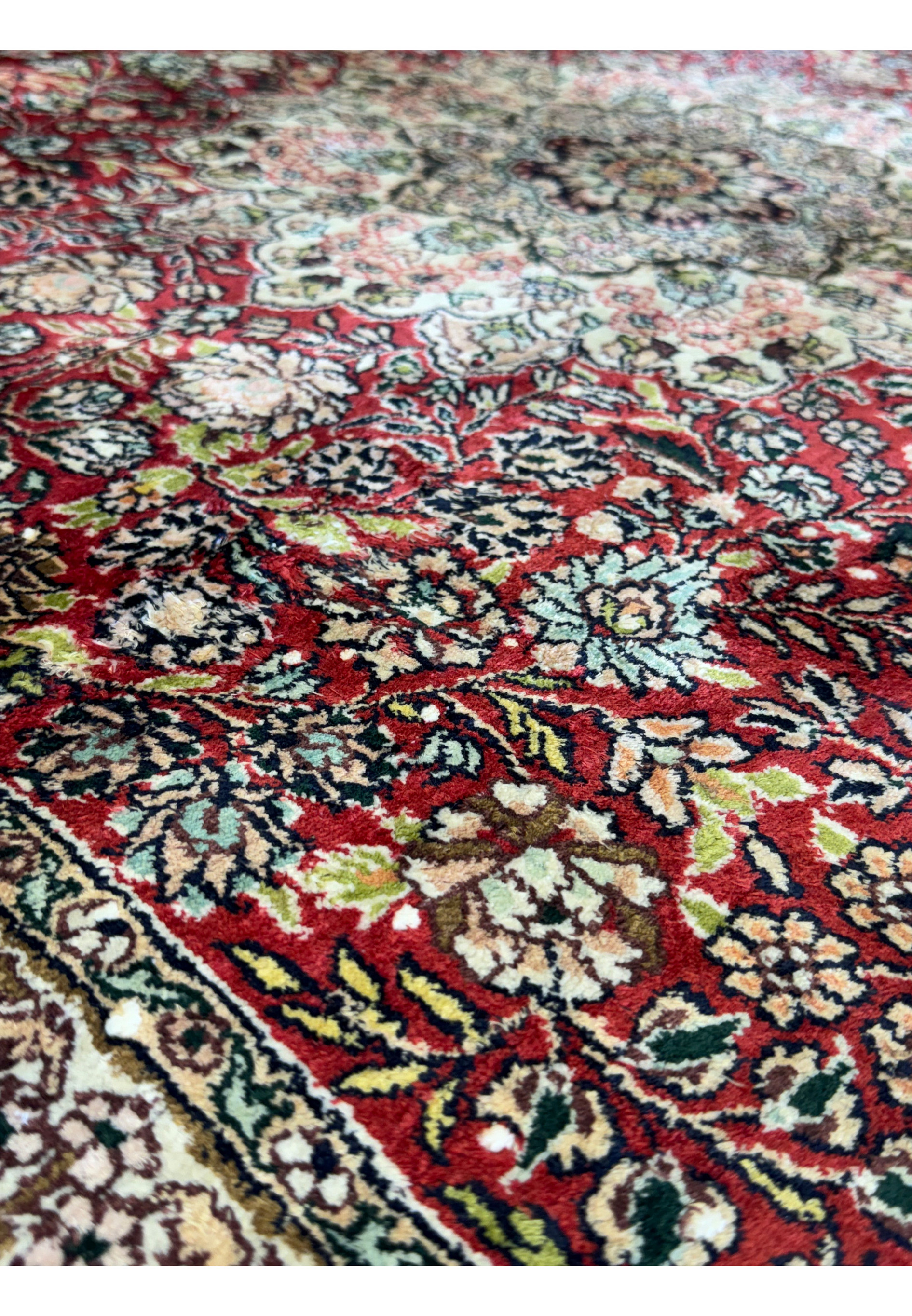 A close-up of the central medallion of the 5 x 8 Oriental Kashmir Silk Rug, emphasizing the complex design and vibrant color palette.