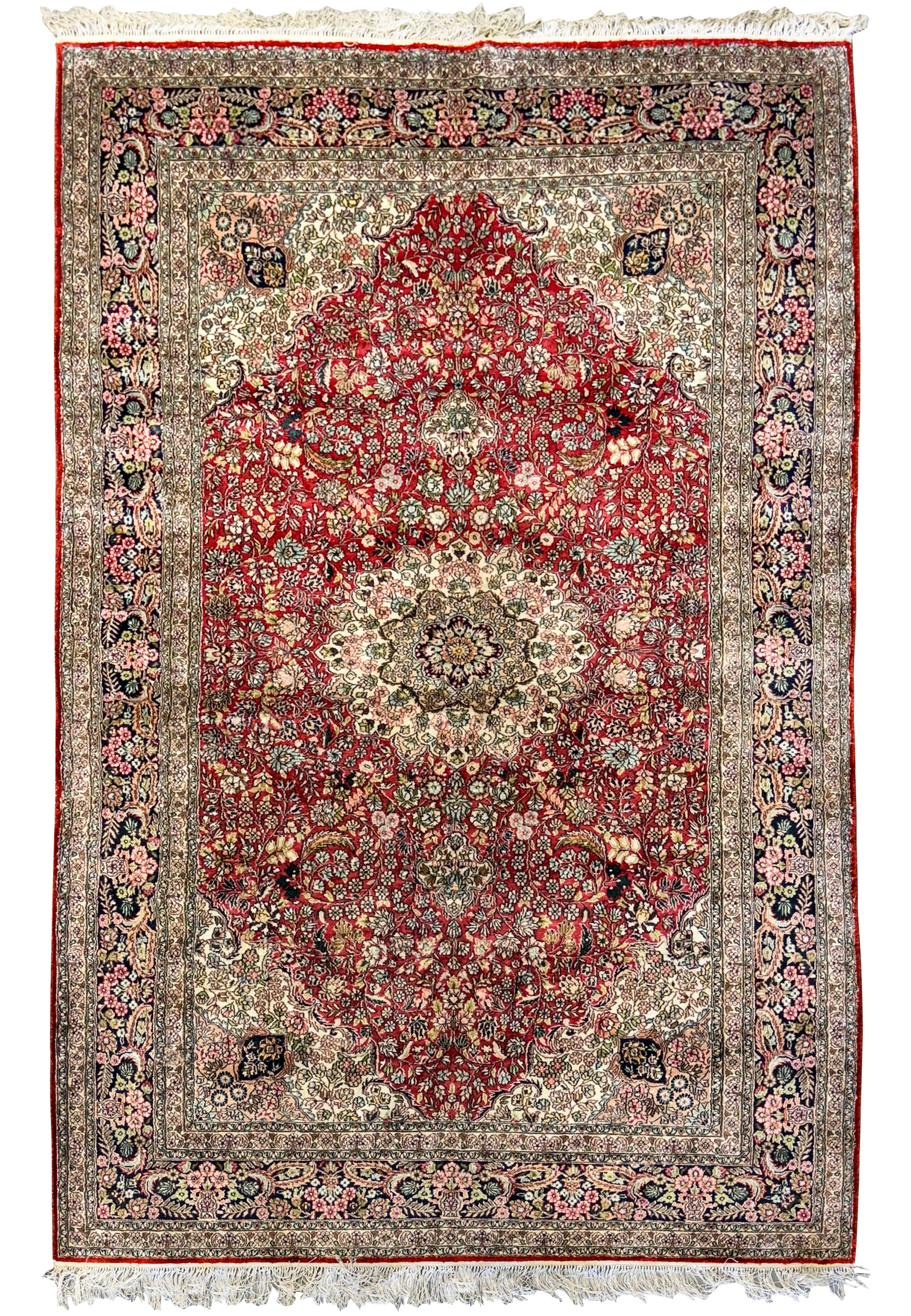 A close-up view of the intricate central medallion of a 5 x 8 Oriental Kashmir Silk Rug, showcasing its vibrant red color and detailed floral motifs.