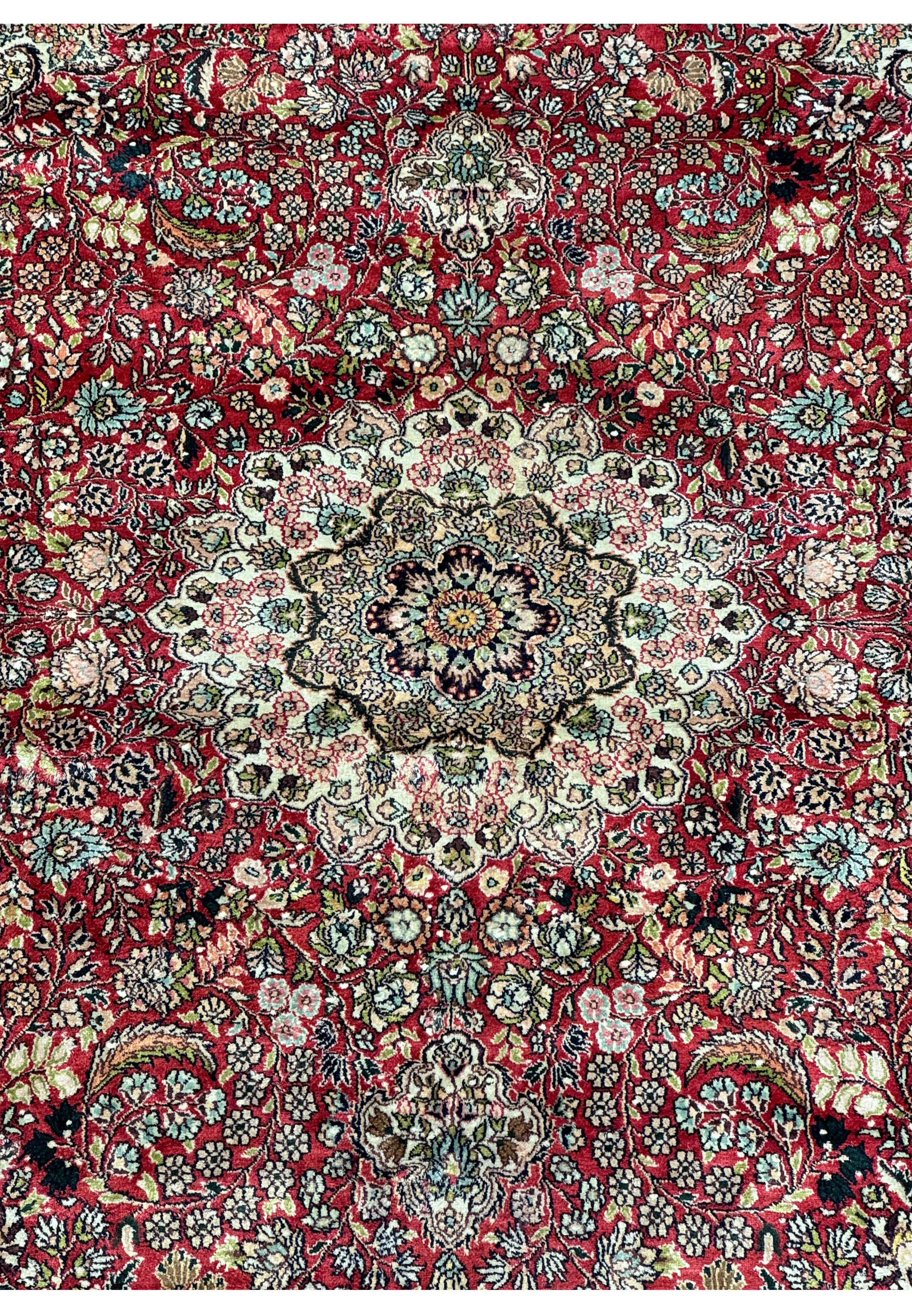 Detailed view of the corner of the 5 x 8 Oriental Kashmir Silk Rug, focusing on the intricate floral border and fringe detailing.