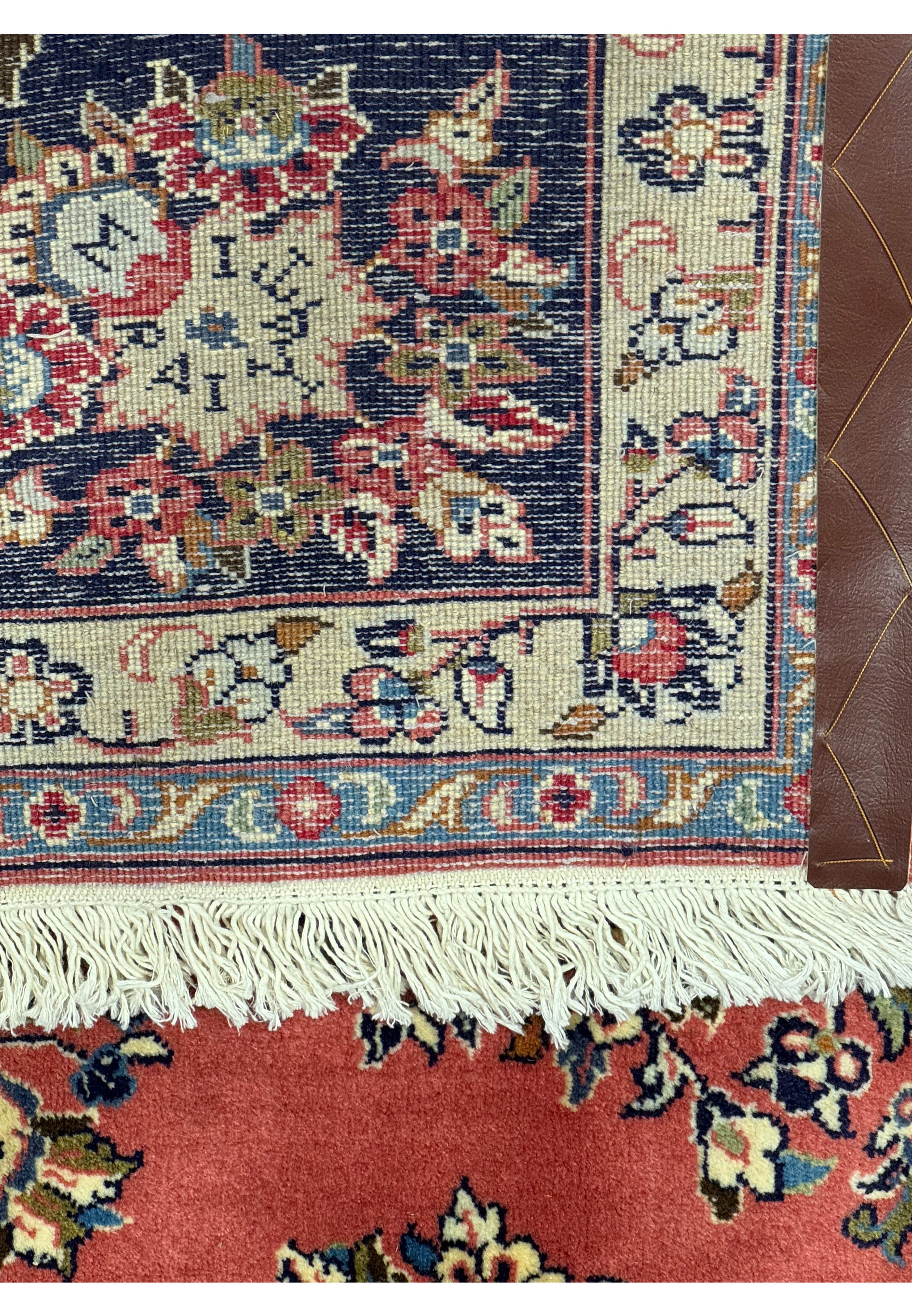 Back view of a 6'9 x 9'8 Persian Yazd rug showcasing the intricate knotting and high-quality craftsmanship, highlighting the rug's durability and fine detail.