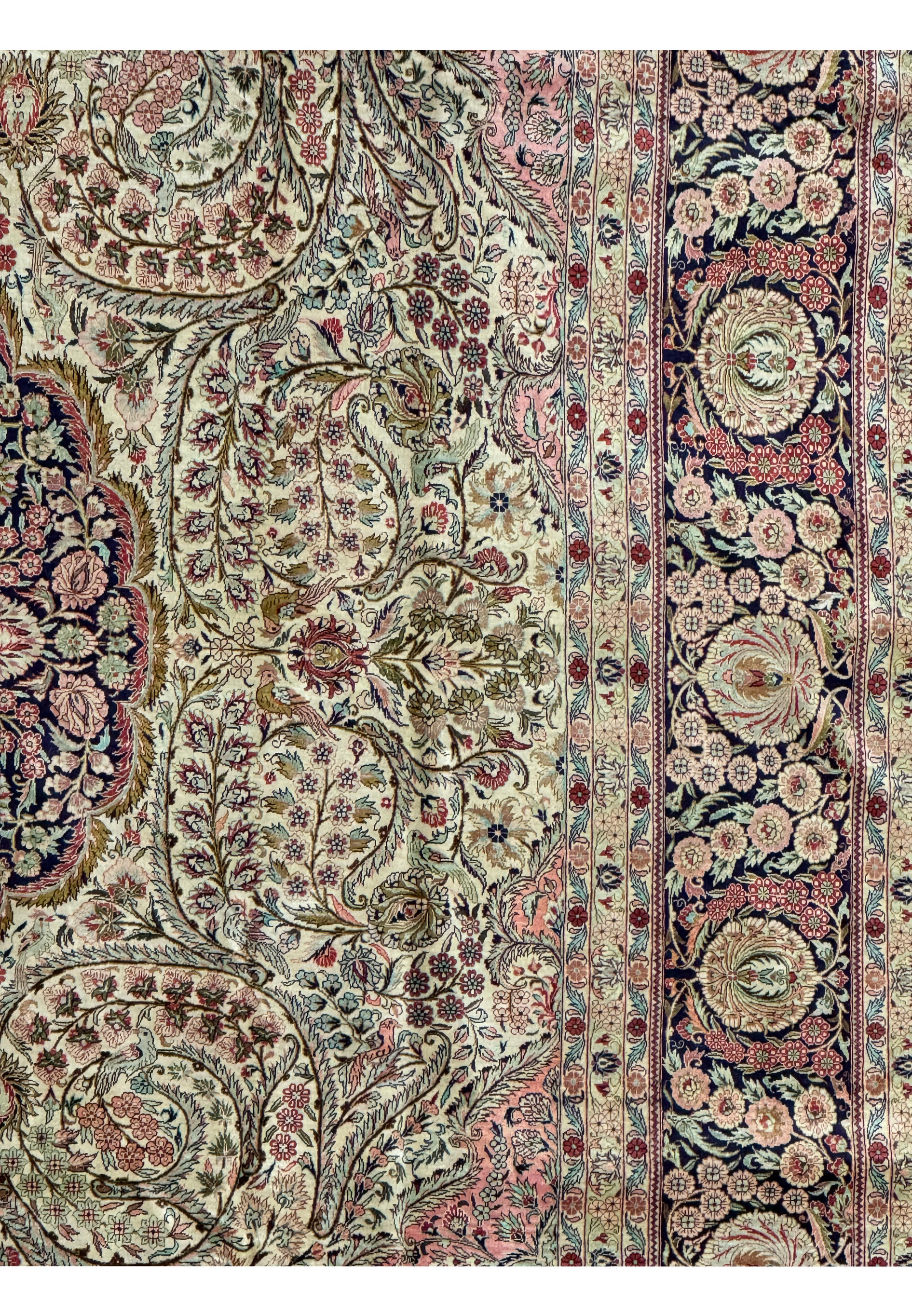 Midfield and border of a Persian Tabriz 100% silk rug showcasing floral and medallion design