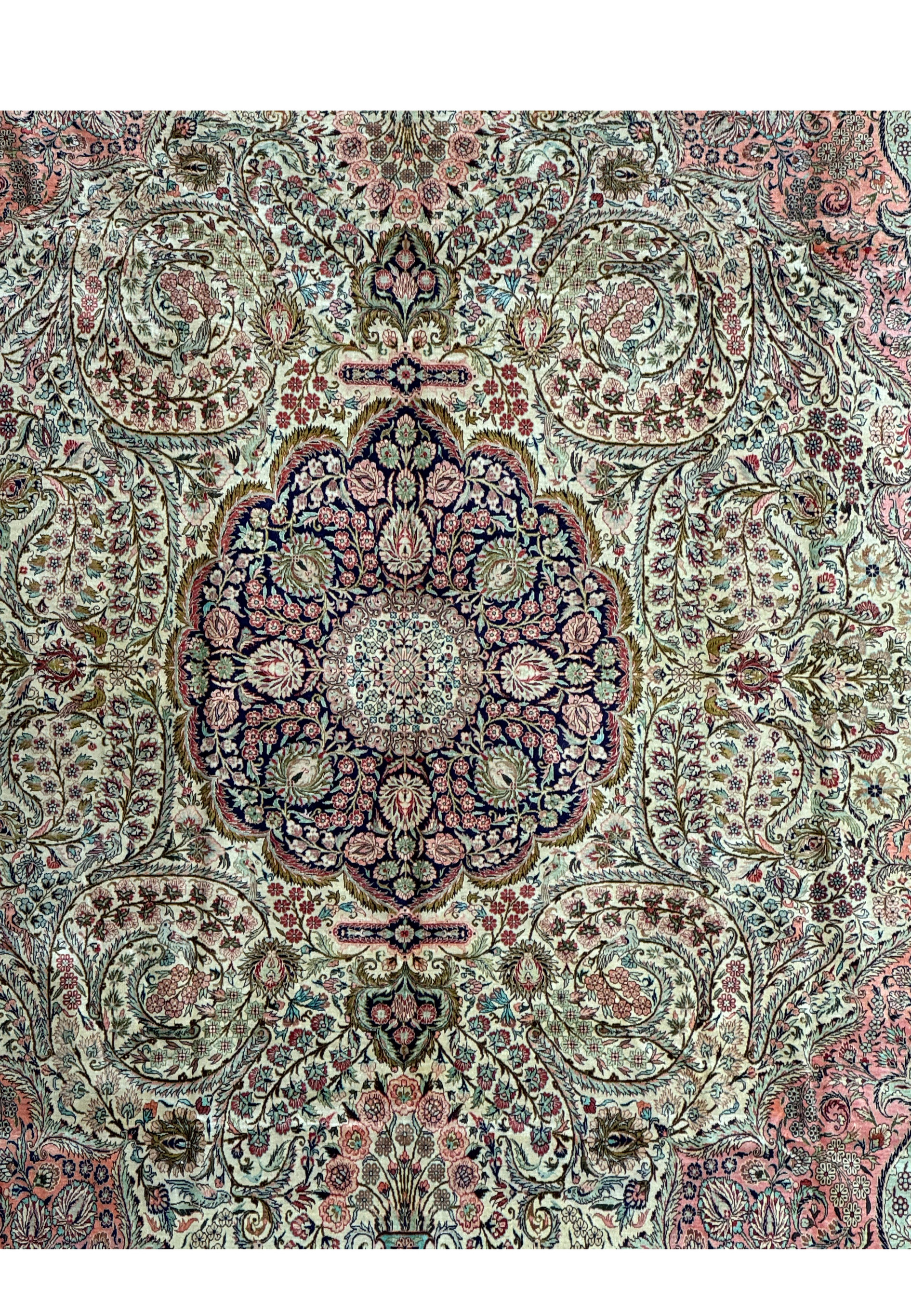 Midfield and central medallion of a Persian Tabriz 100% silk rug with detailed floral patterns
