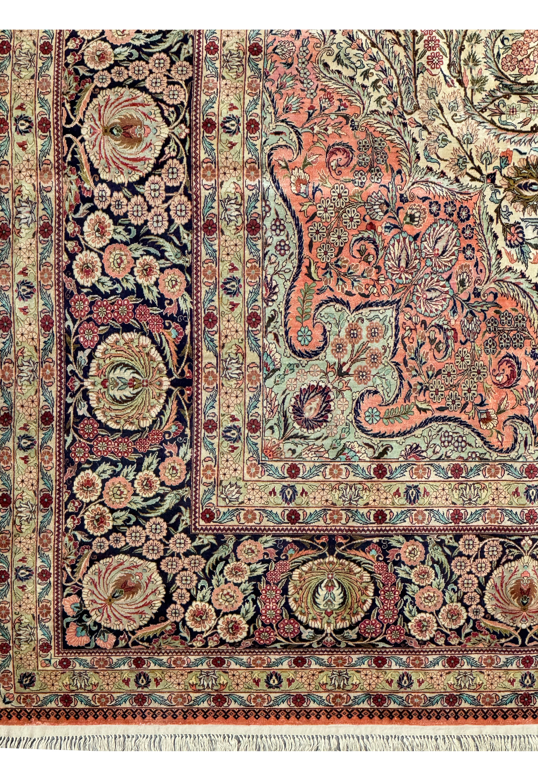 Top section of a Persian Tabriz 100% silk rug showcasing intricate floral design and fringe