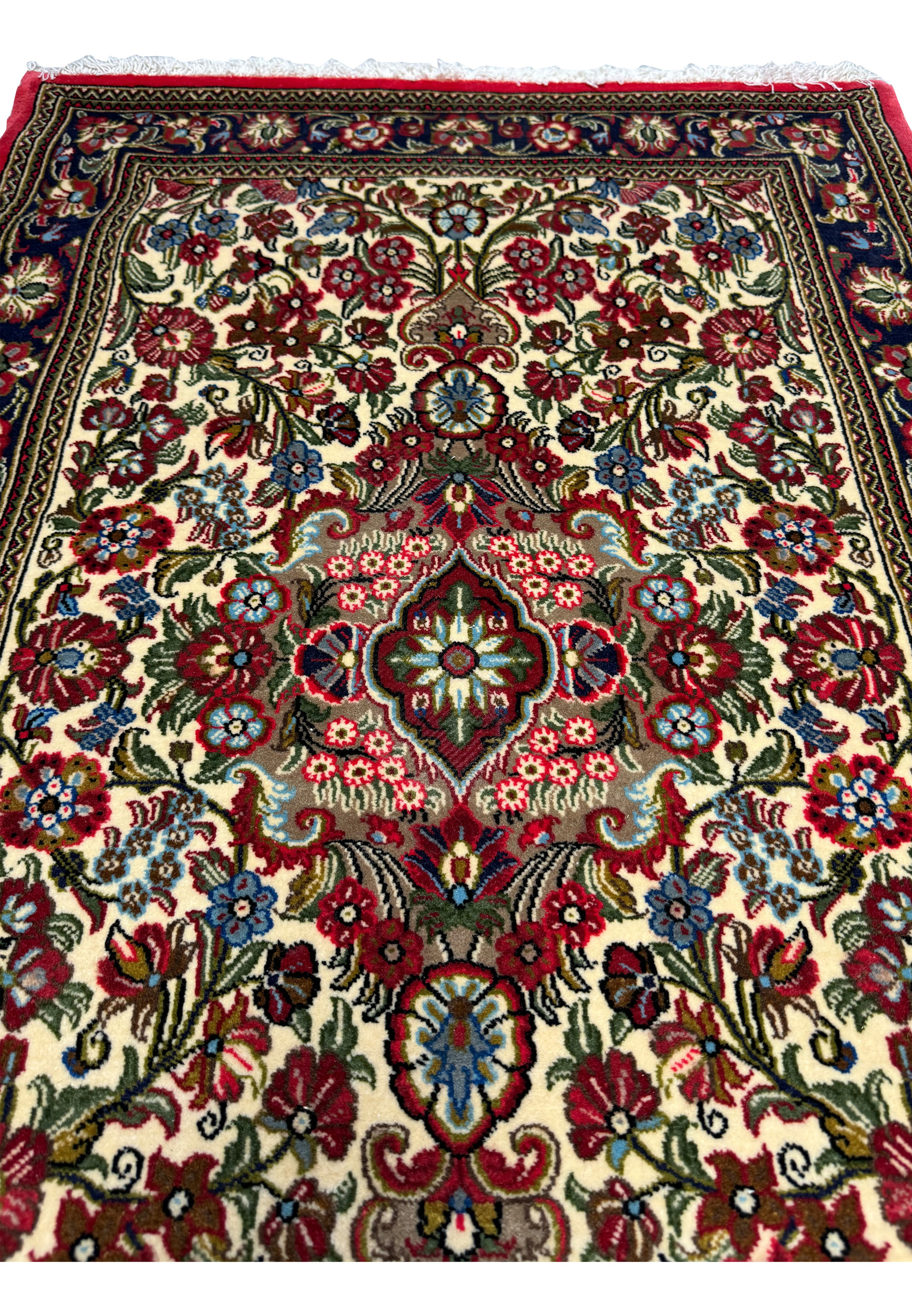 Close-up of the border and fringe of a Persian Qum Kork rug