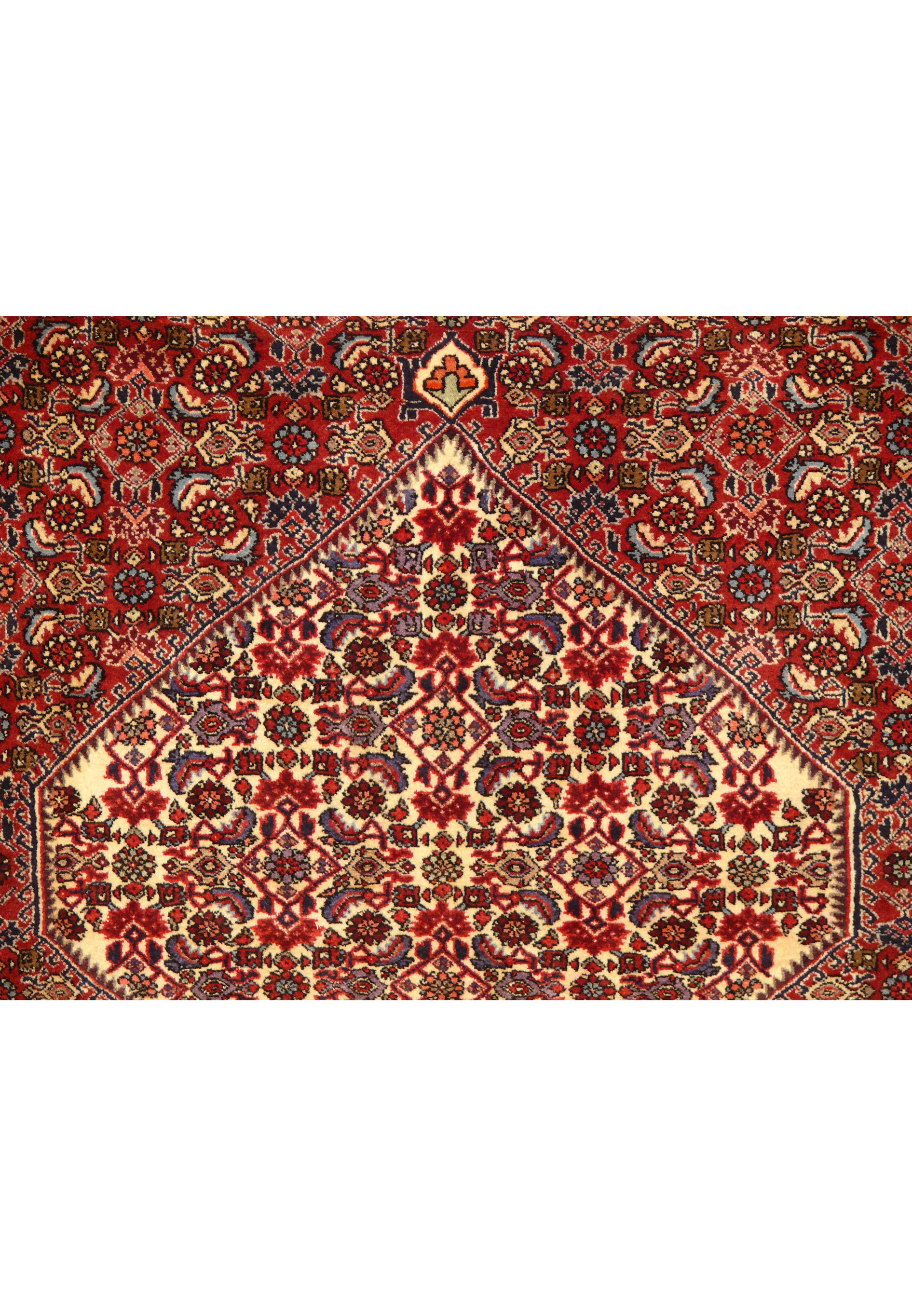 Close-up of the 5'5 x 10 Persian Bijar Rug's central medallion and surrounding floral patterns in rich crimson and navy blue