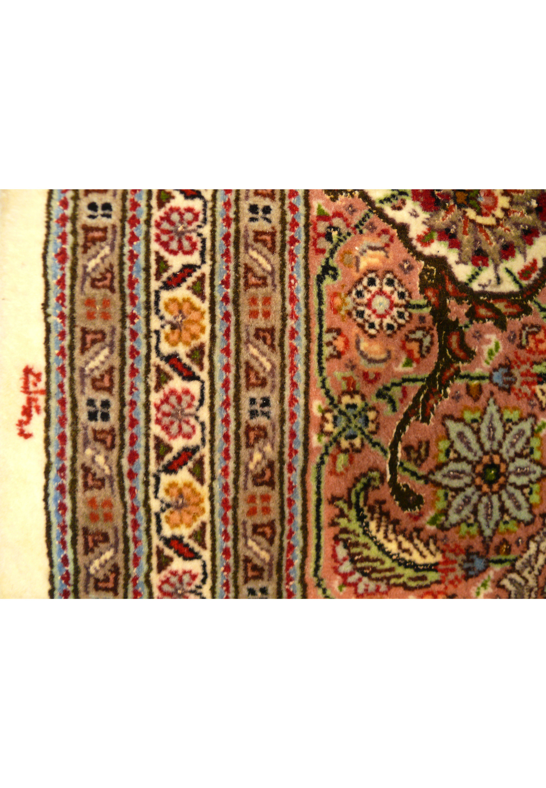Left edge of the Tabriz Mahi Silk Rug with the master weaver's signature, ensuring authenticity.
