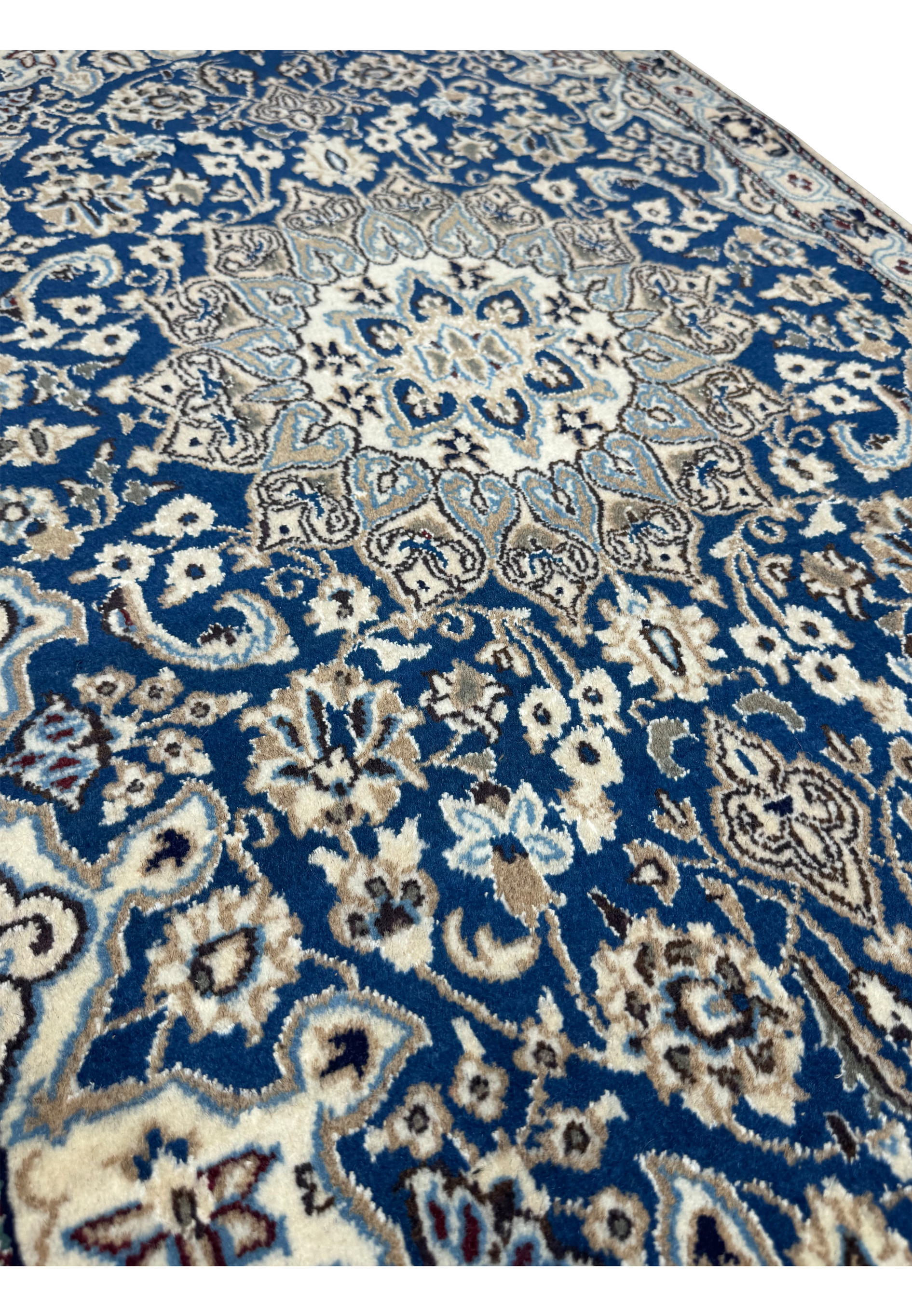 Angled perspective of the 3x5 Persian Nain Rug, illustrating the rug's texture and depth of patterns.
