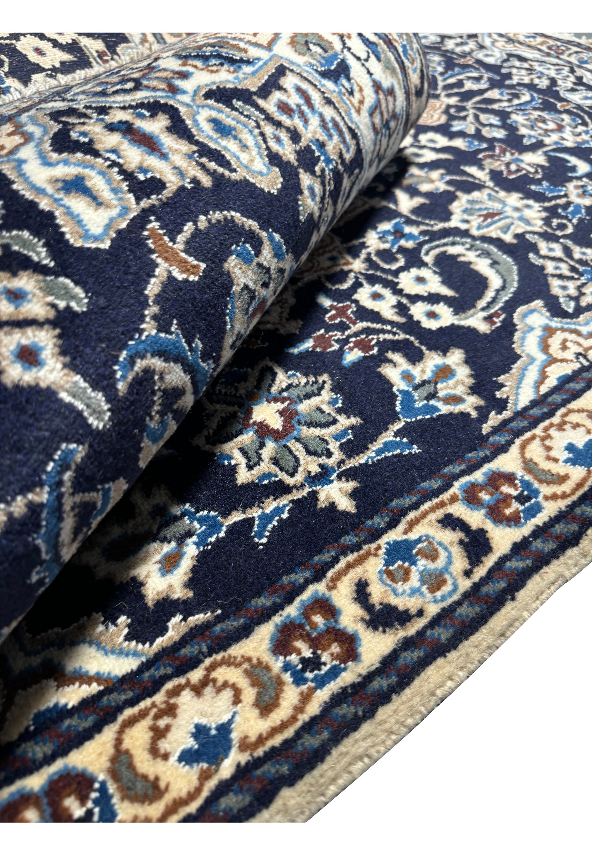 Rolled view of the 3x5'3 Persian Nain Rug highlighting its thickness and high-quality wool.