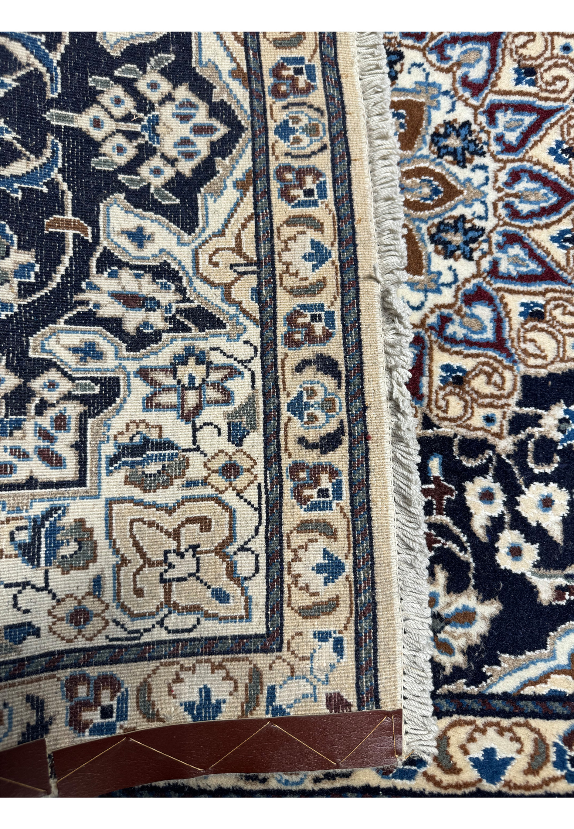 Backside of the 3x5'3 Persian Nain Rug showing the fine weave and density, with a measuring tape to indicate quality.