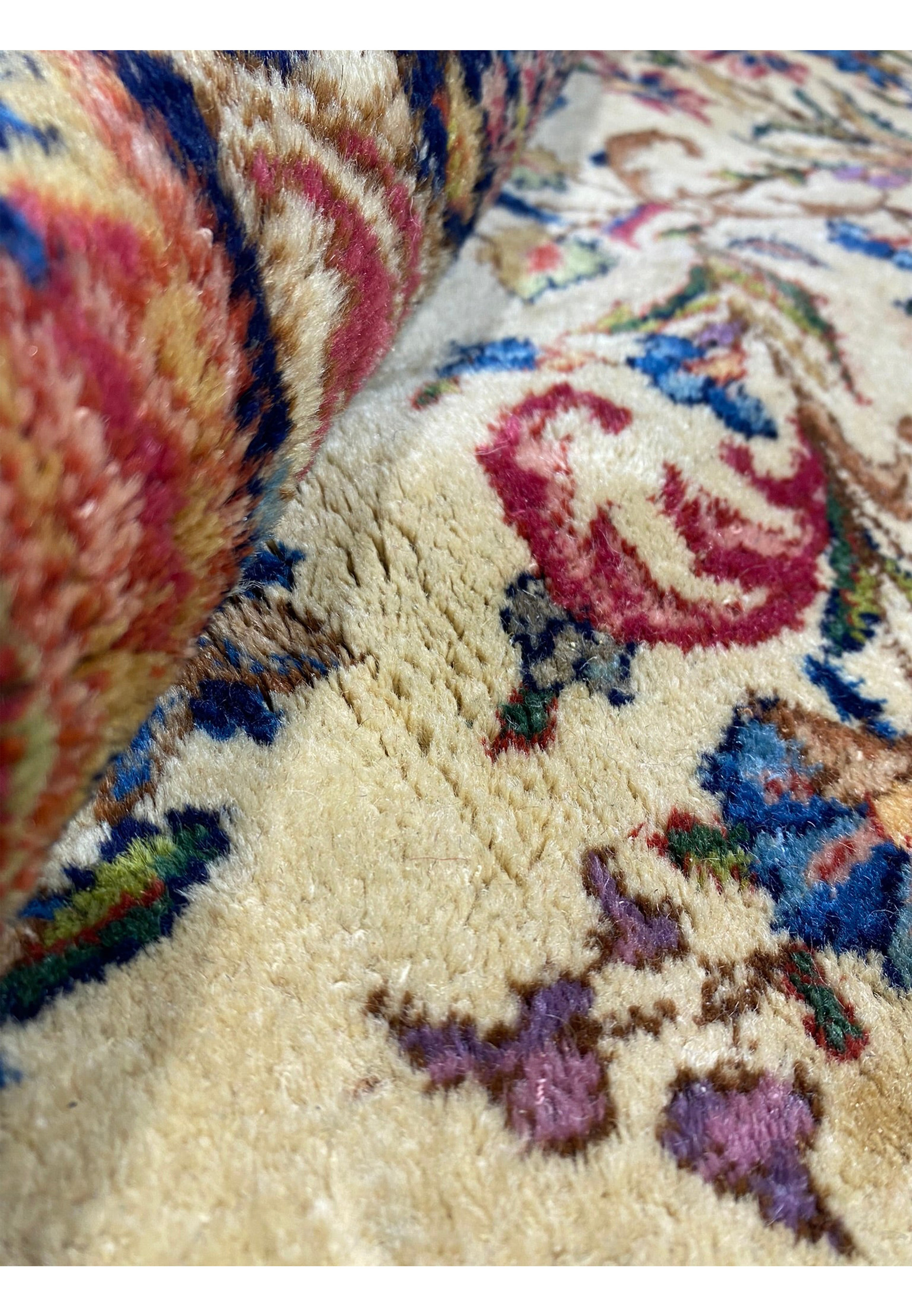Rolled texture view of the 9' x 17'8" Antique Persian Kerman Lavar Rug.