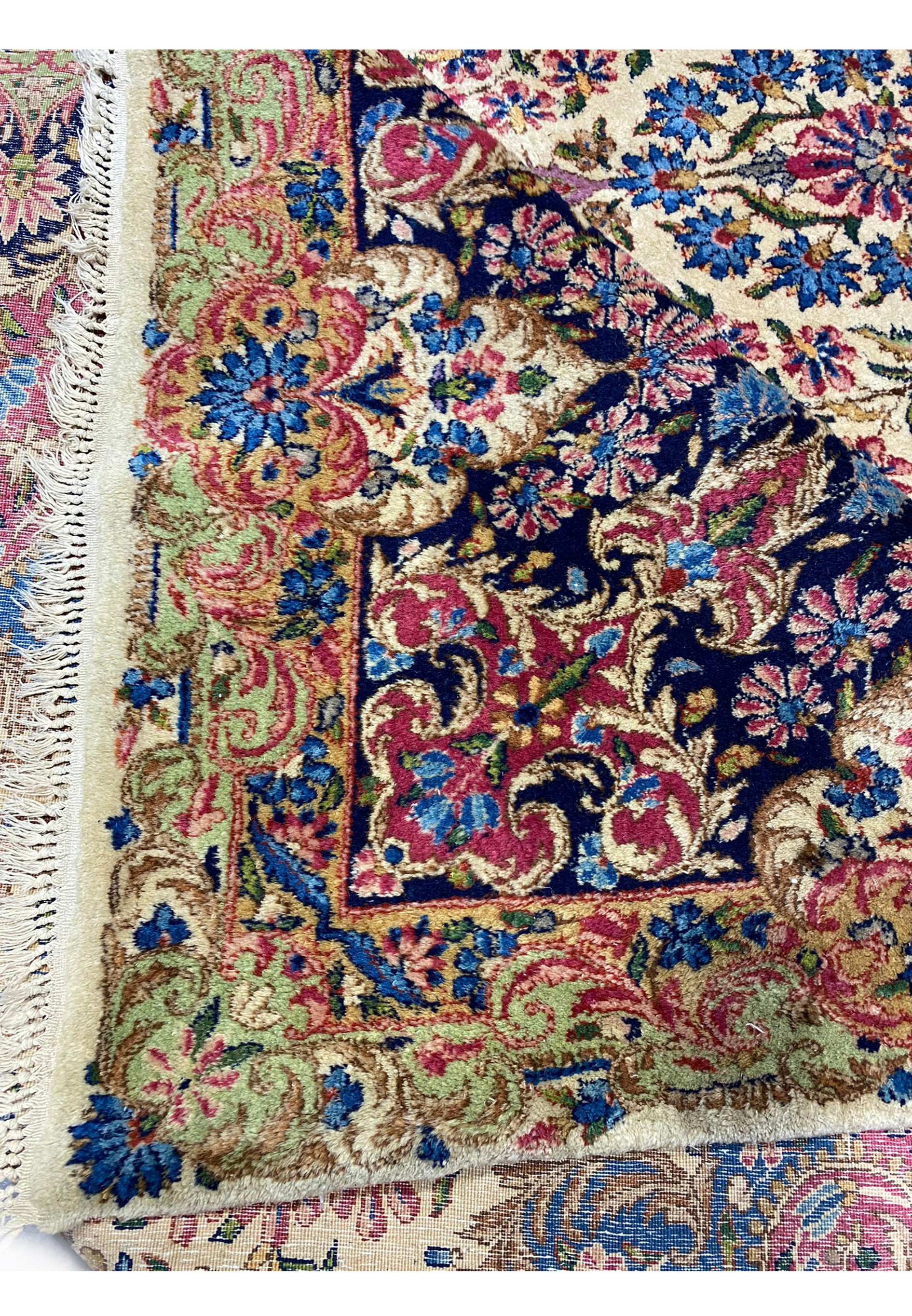 Detailed view of the border on a 9' x 17'8" Antique Persian Kerman Lavar Rug.