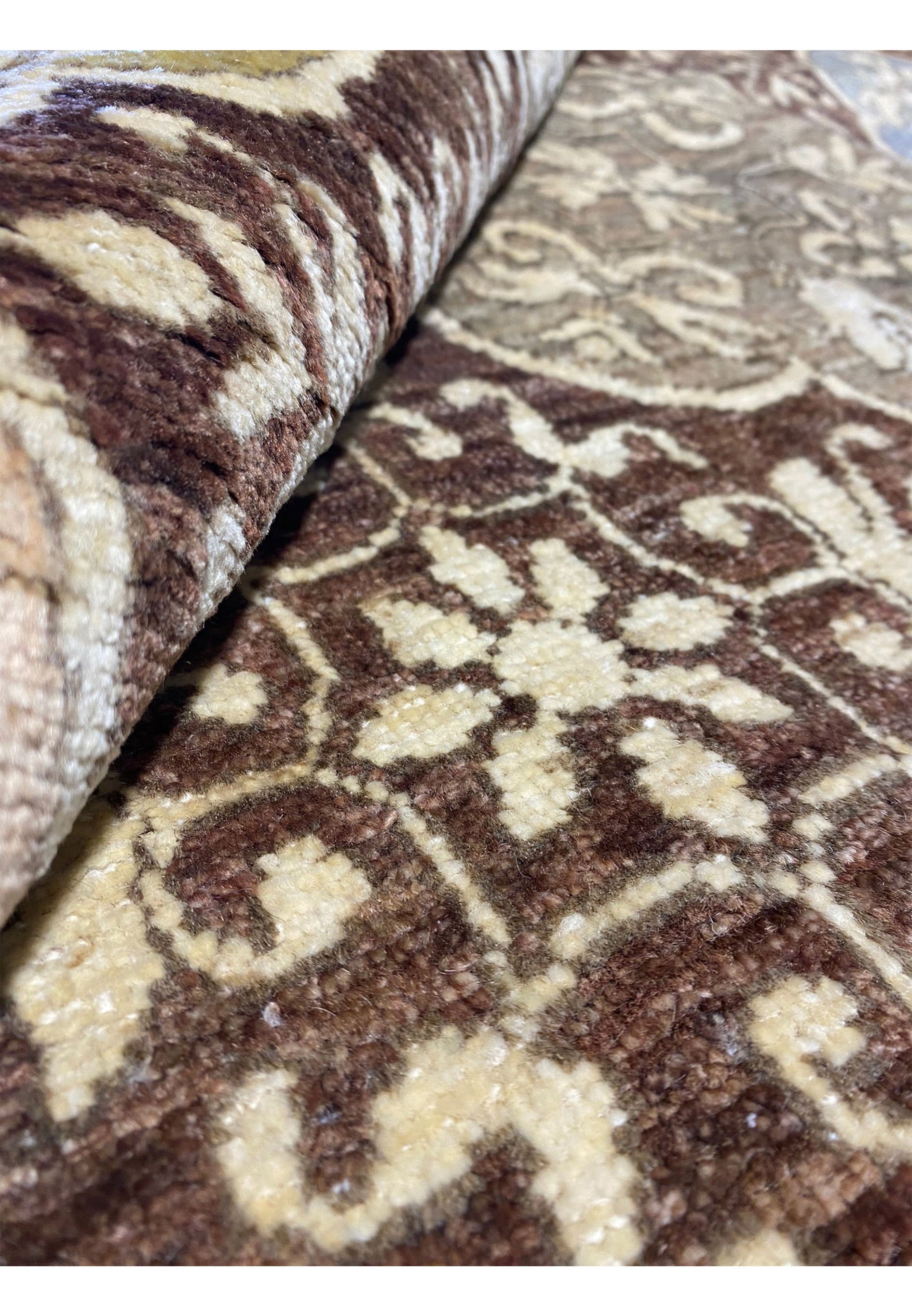 Rolled 13x16 Ziglar rug showcasing its texture and pile thickness.