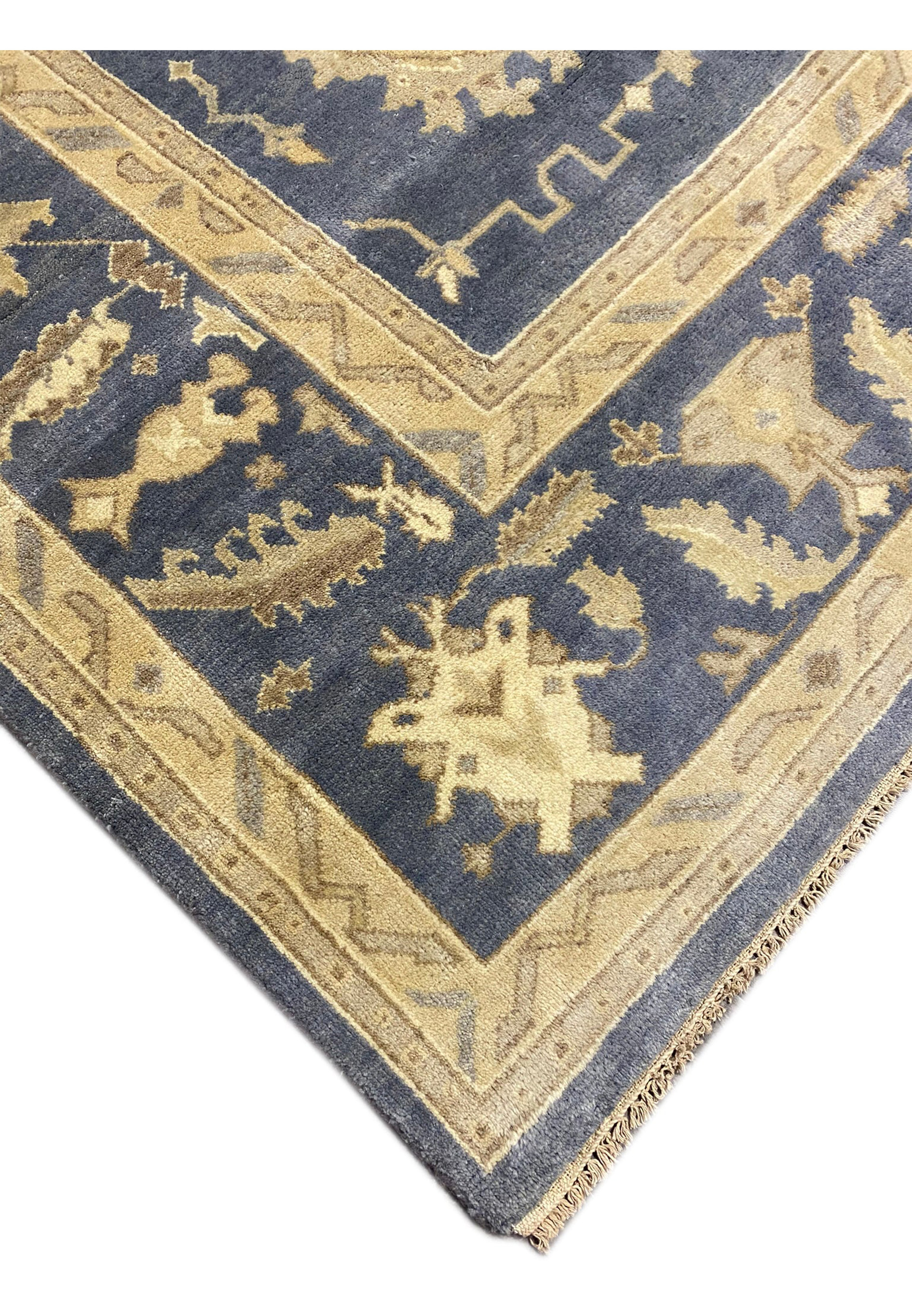 Close-up of the golden and navy border of the 10'2" x 20' Chobi Rug