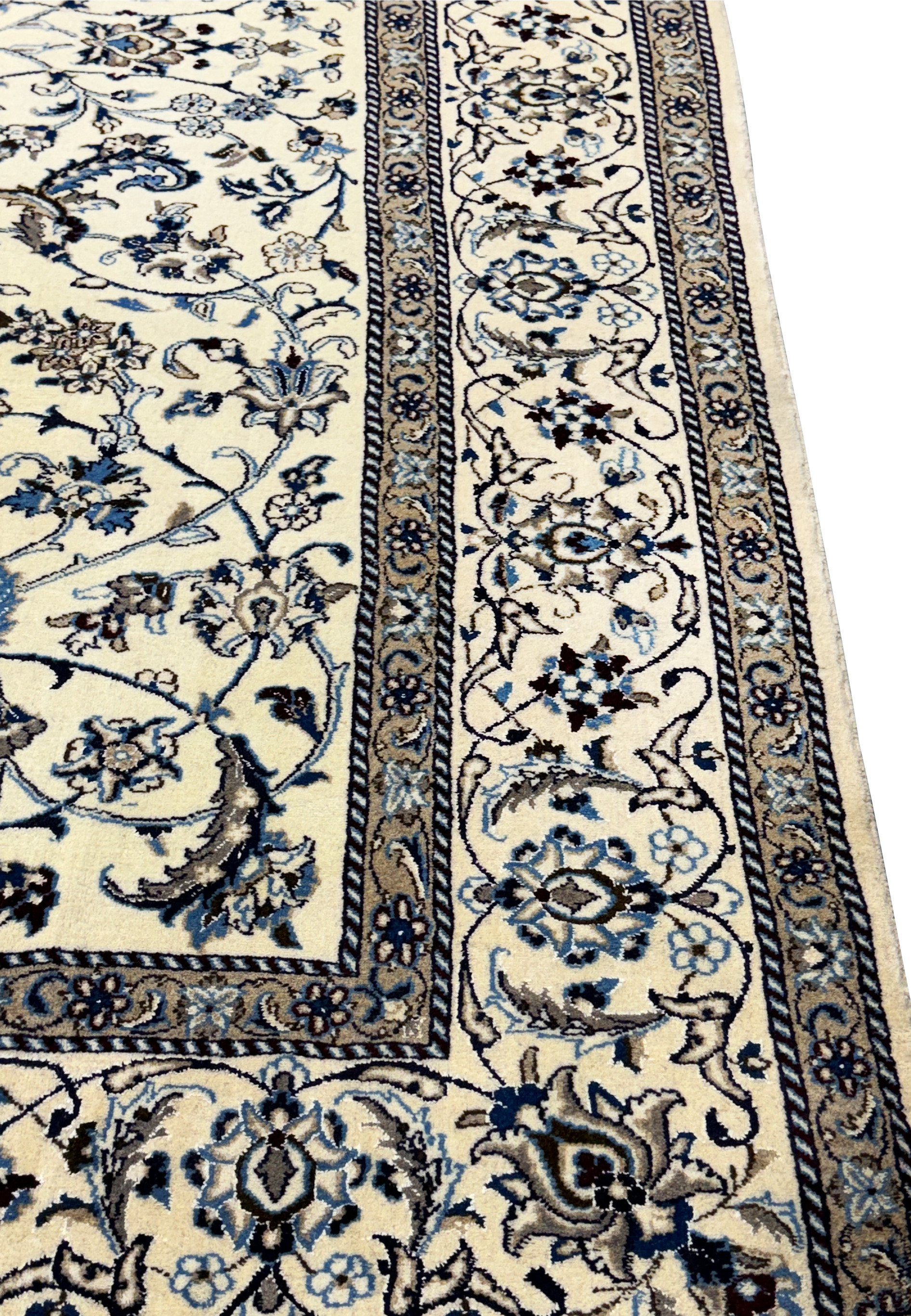 Angled side view of the 8'2 x 11'6 Persian Nain rug highlighting the floral patterns and silk details.