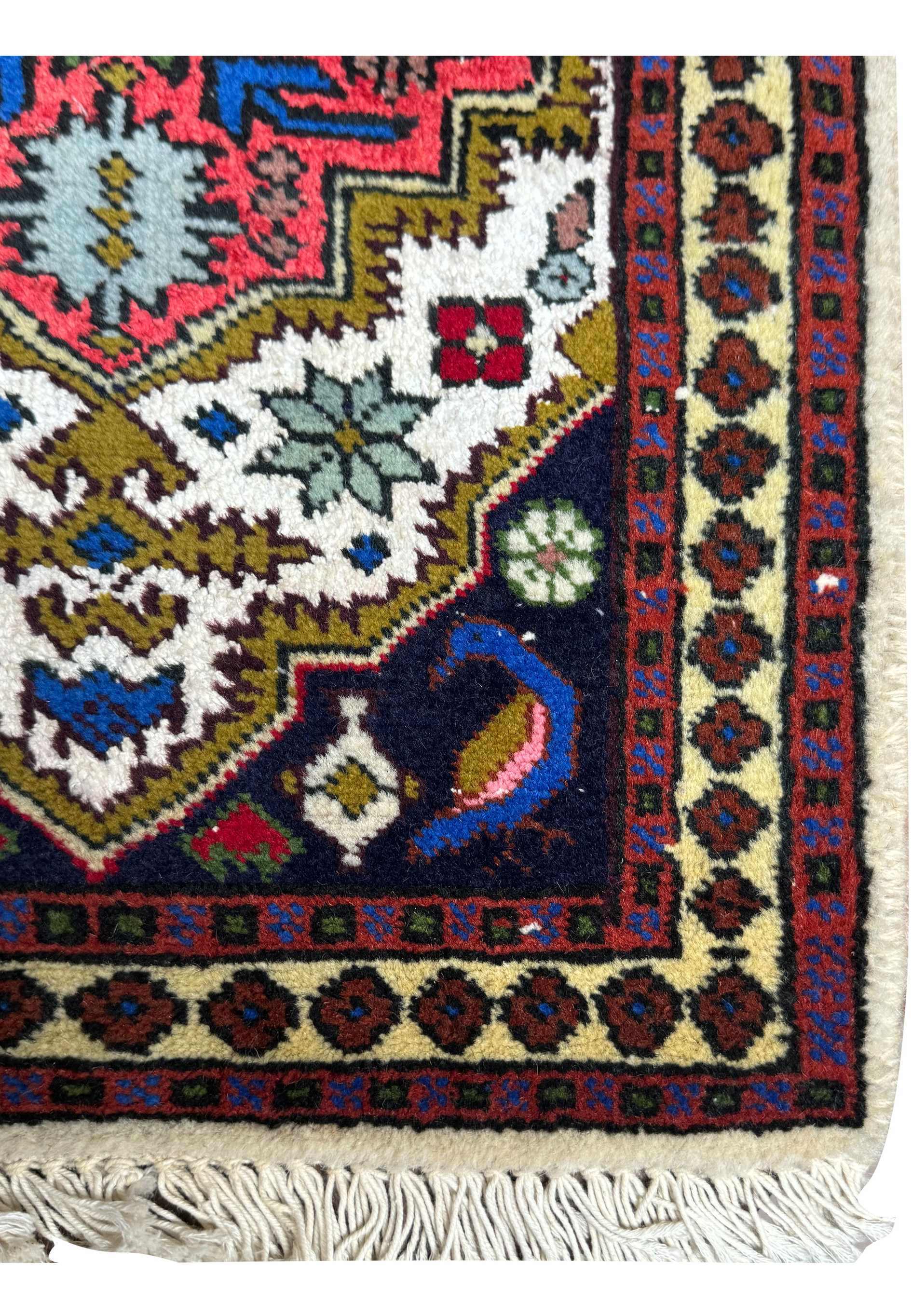 Border detail of the 1'3 x 2' Persian Ardebil Baby Rug showcasing intricate geometric patterns and rich color contrasts.