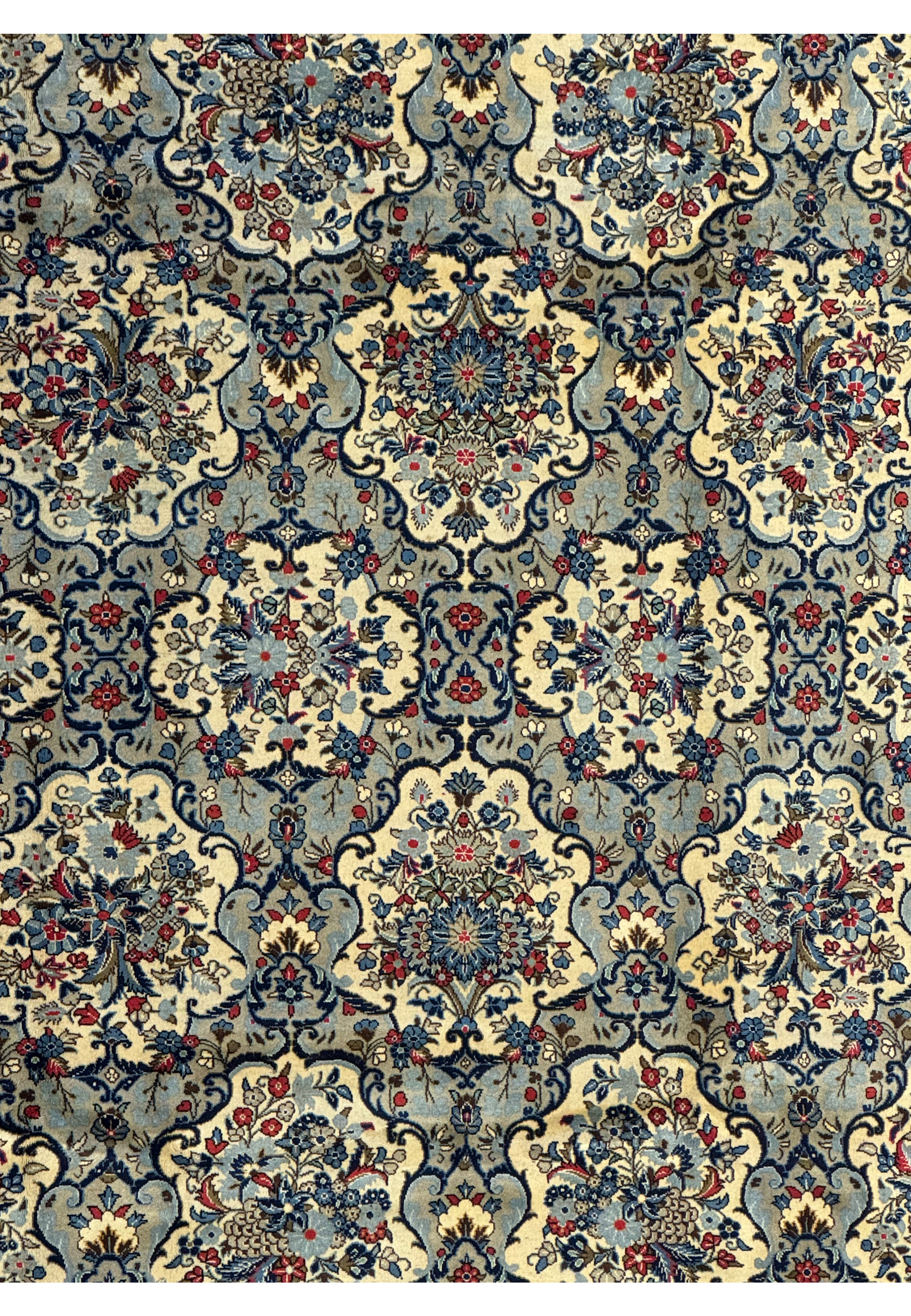 Floral motifs on the 8'2 x 11'6 Persian Kashan Rug, in sky blue and ivory with a red border.