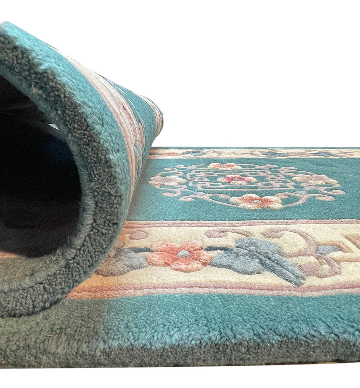 Side view of the rolled Walter Nichols Art Deco Runner showing its thickness and design detail.