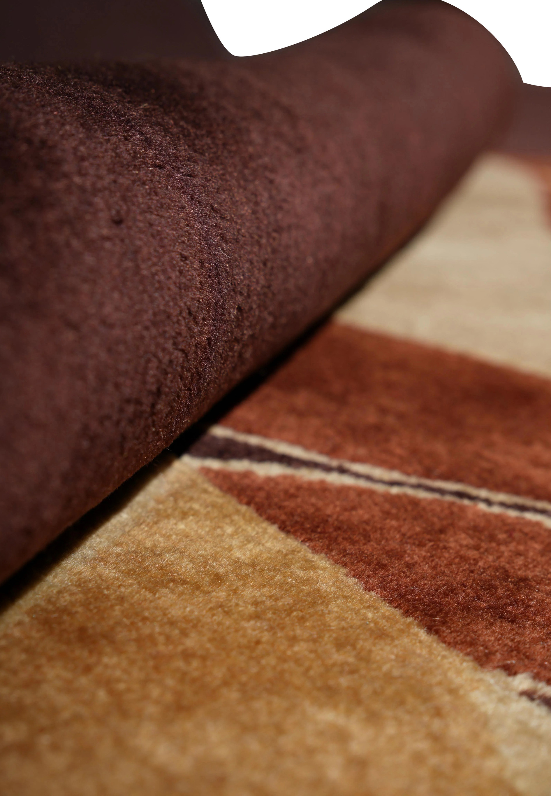 Rolled detail of thick wool pile in modern rug design