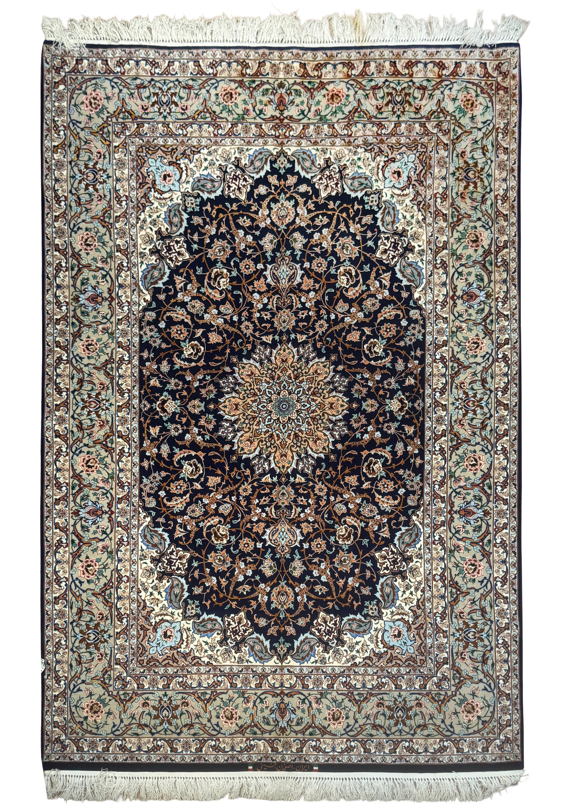 Full view of 4'11 x 7'7 signed Persian Isfahan rug with navy field and intricate floral medallion design in wool and silk