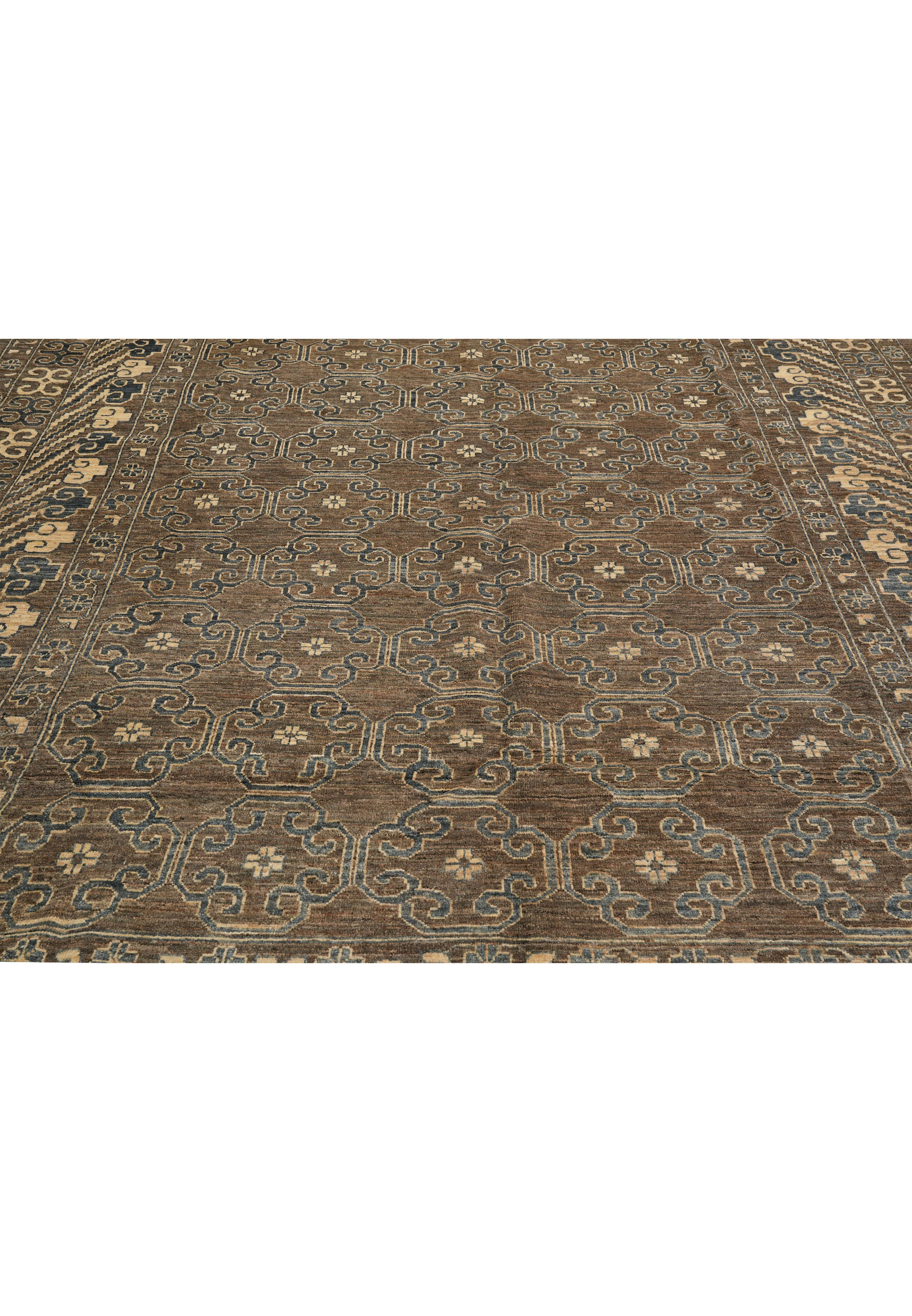 Zigler rug midfield view with repeating geometric floral lattice in grey, brown, and beige, handwoven wool design.