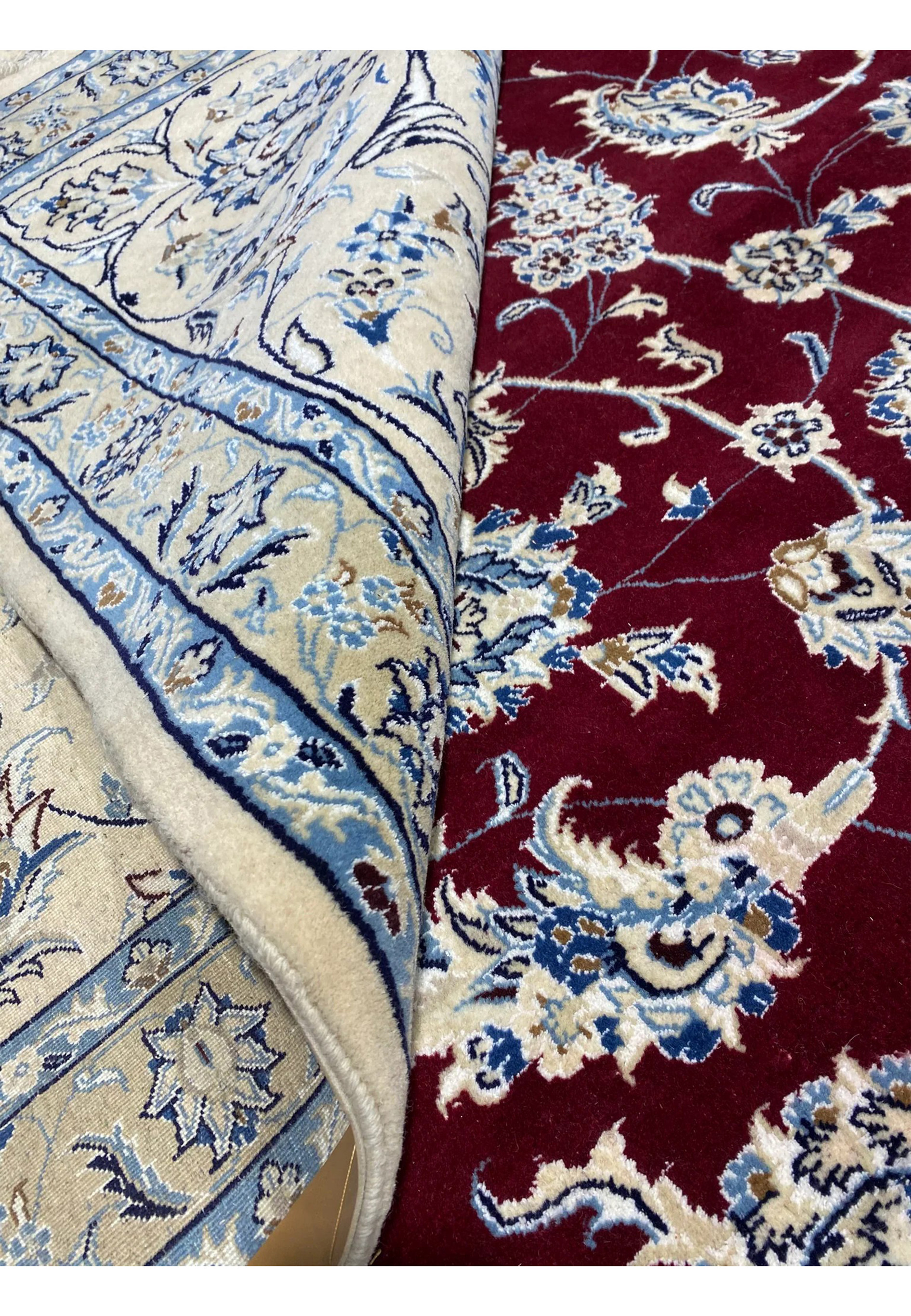 Rolled view of 12'9 x 18'8 Persian Nain 9 LAA wool and silk rug showcasing fine weave