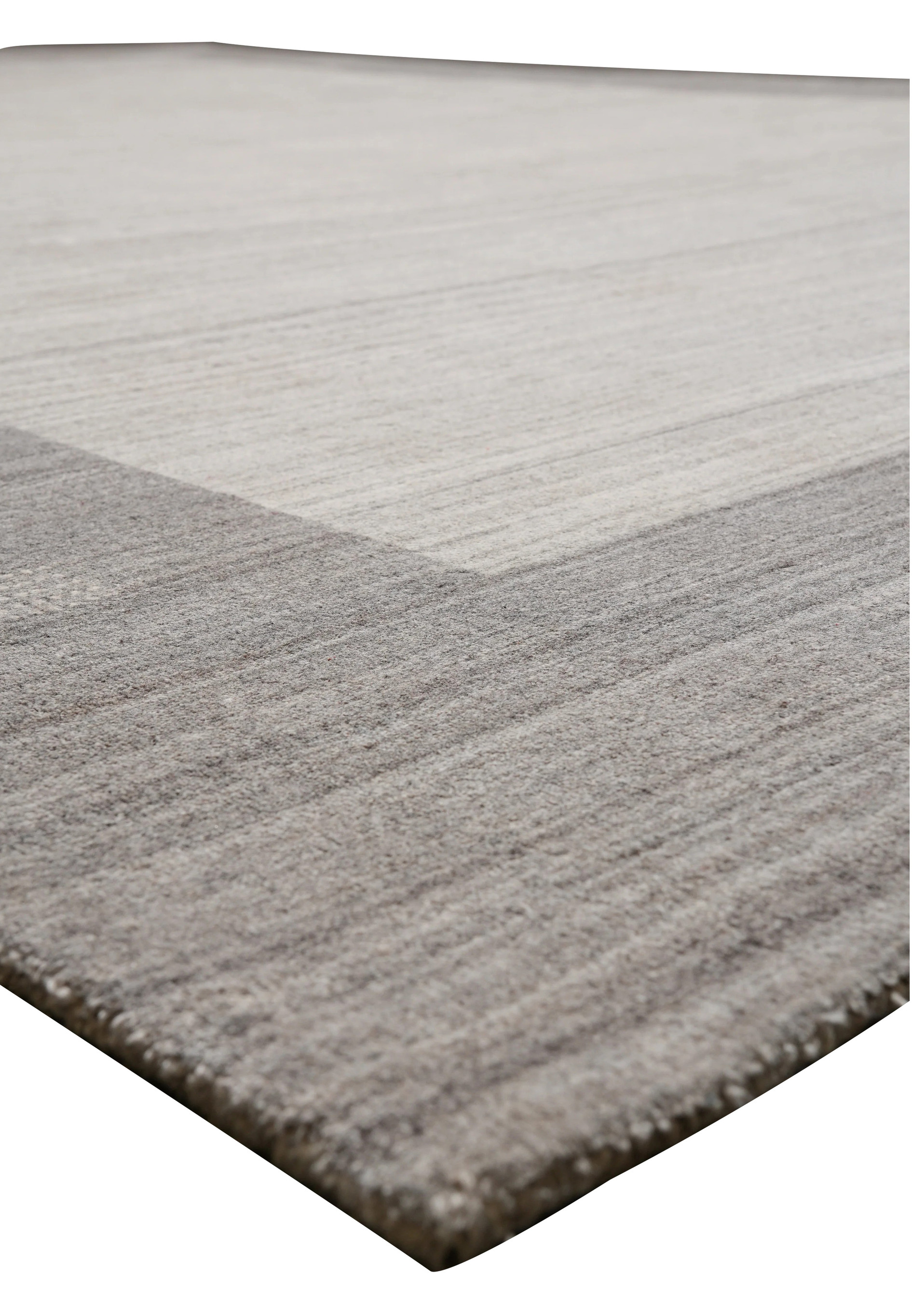 Contemporary solid gray wool rug angled view with subtle tonal variations