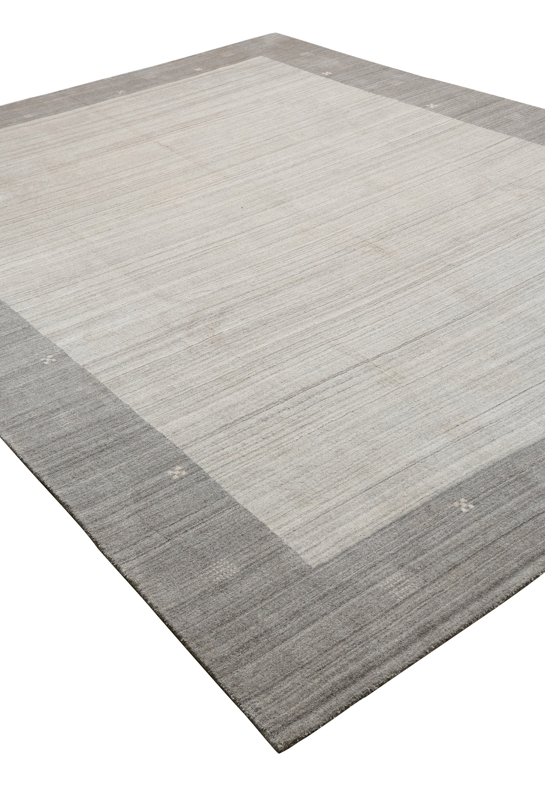 Contemporary solid gray wool rug angled view with subtle tonal variations