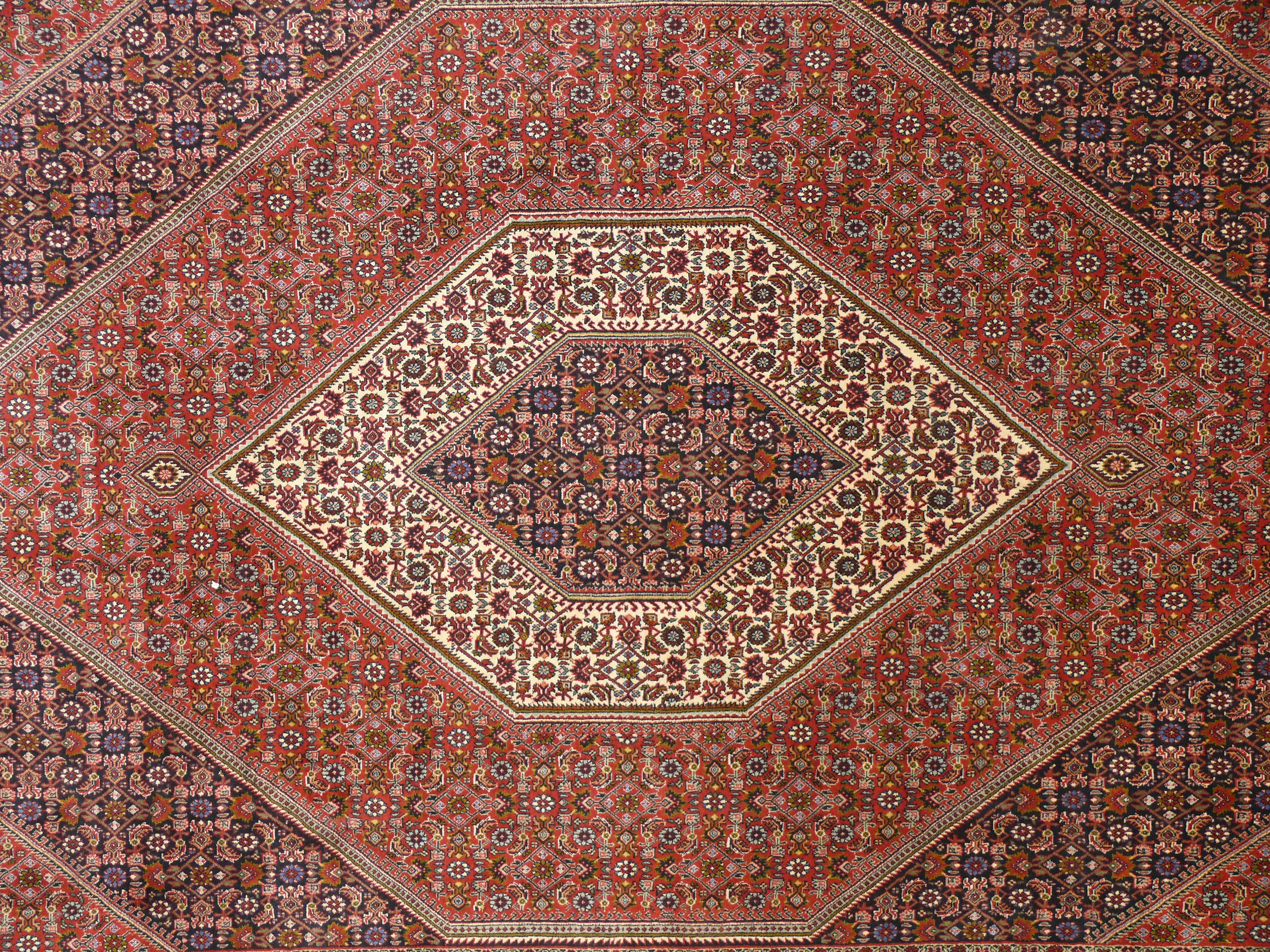 Close-up midfield view of Persian Bijar rug with dense Herati floral lattice design