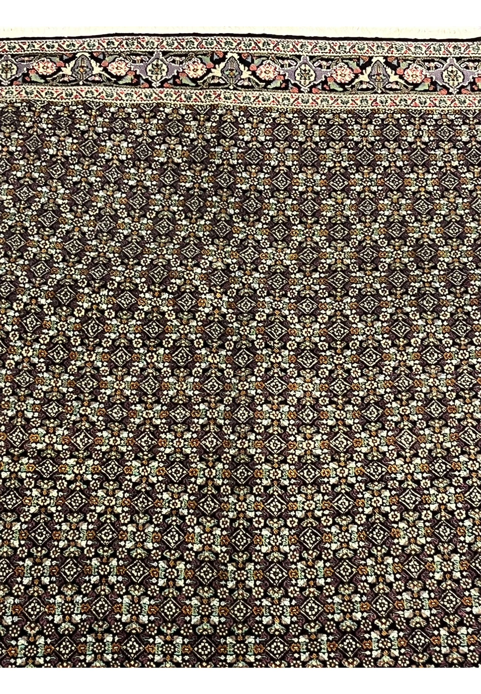 Close-up of repeating diamond lattice field with Mahi motifs on Tabriz rug