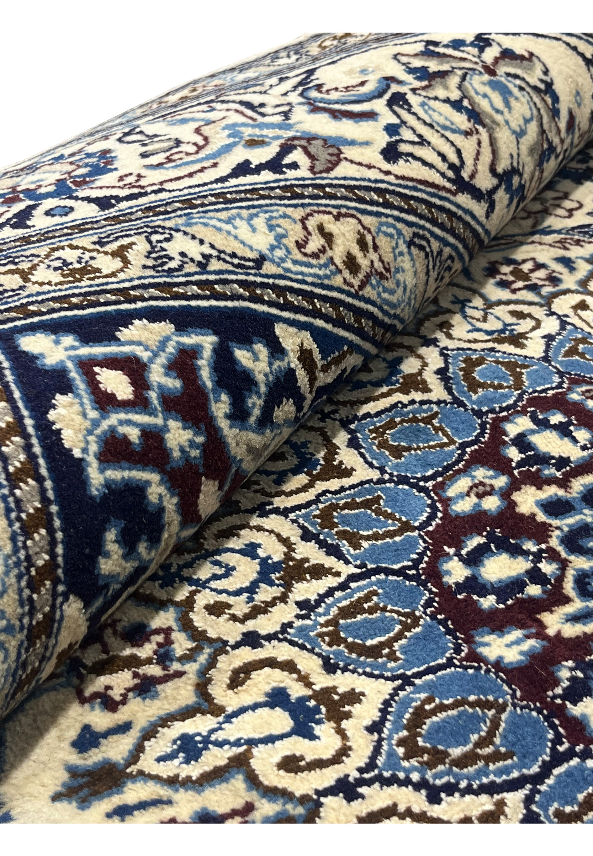 Rolled view of 6'7 x 6'7 Square Persian Nain Rug with silk highlights showing ivory field, navy floral border, and burgundy medallion details