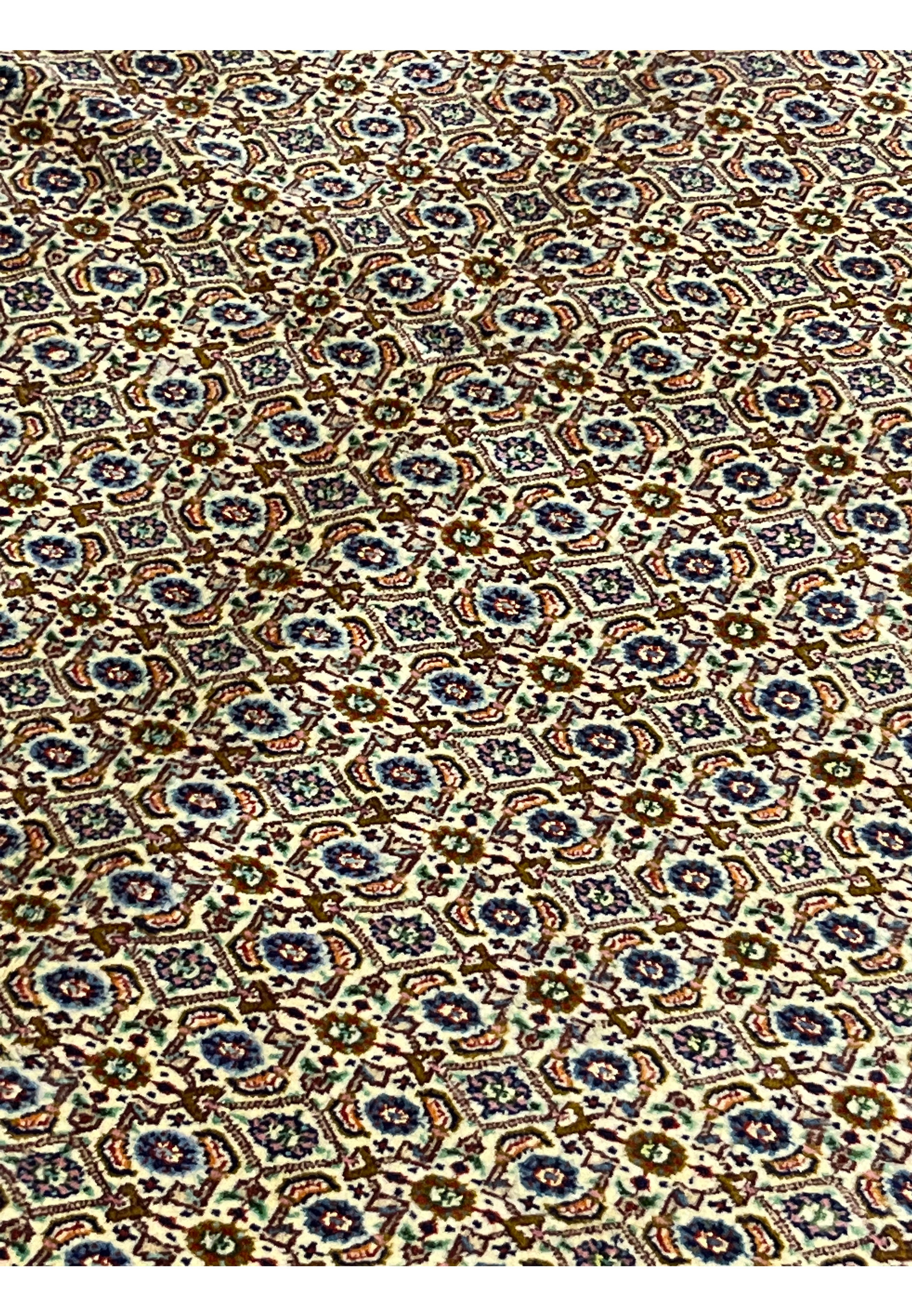 Midfield of Persian Moud rug showing repeating Herati motifs in ivory and navy