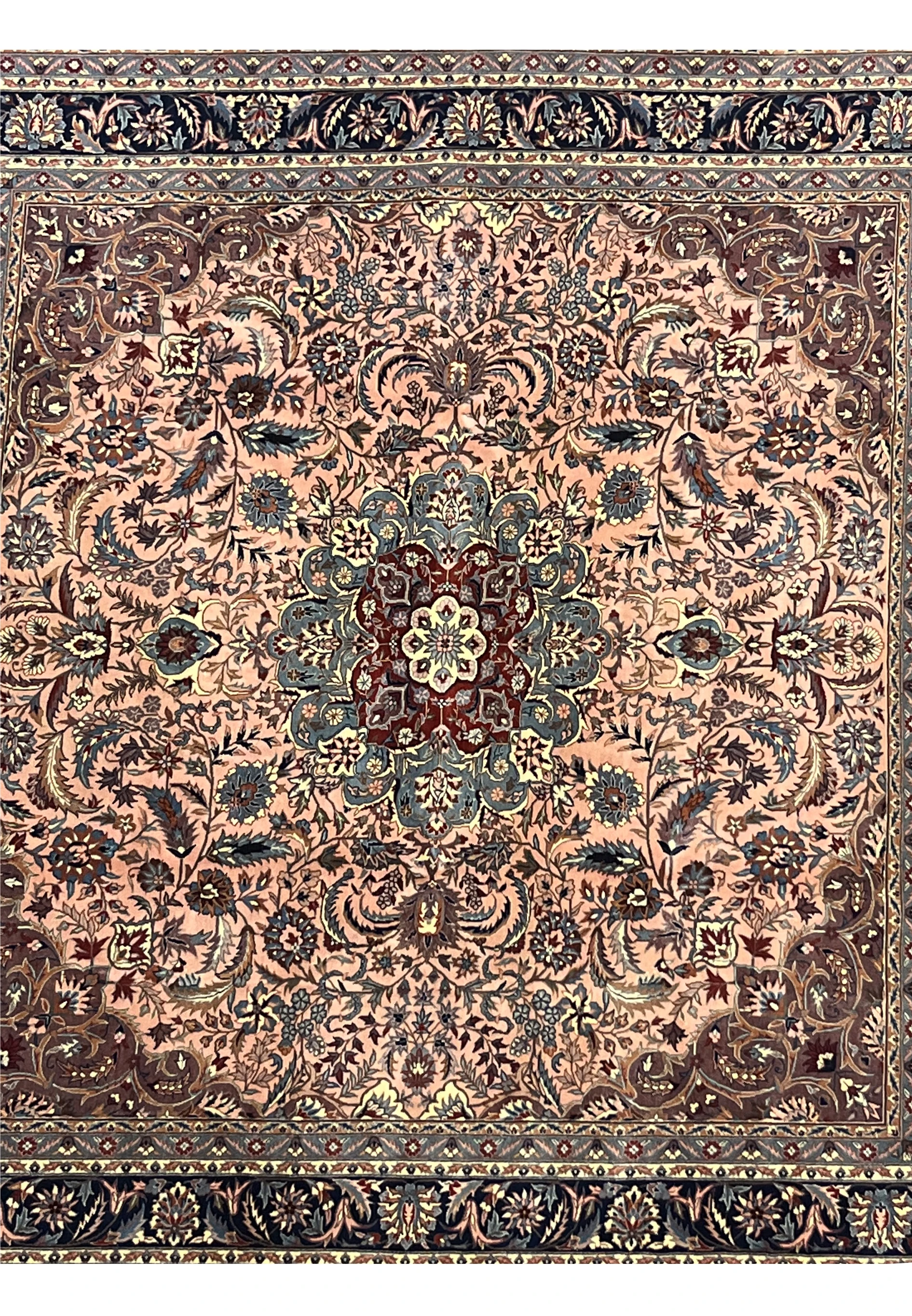 Close-up of Persian Tabriz rug’s central medallion with burgundy, blue, and ivory floral patterns