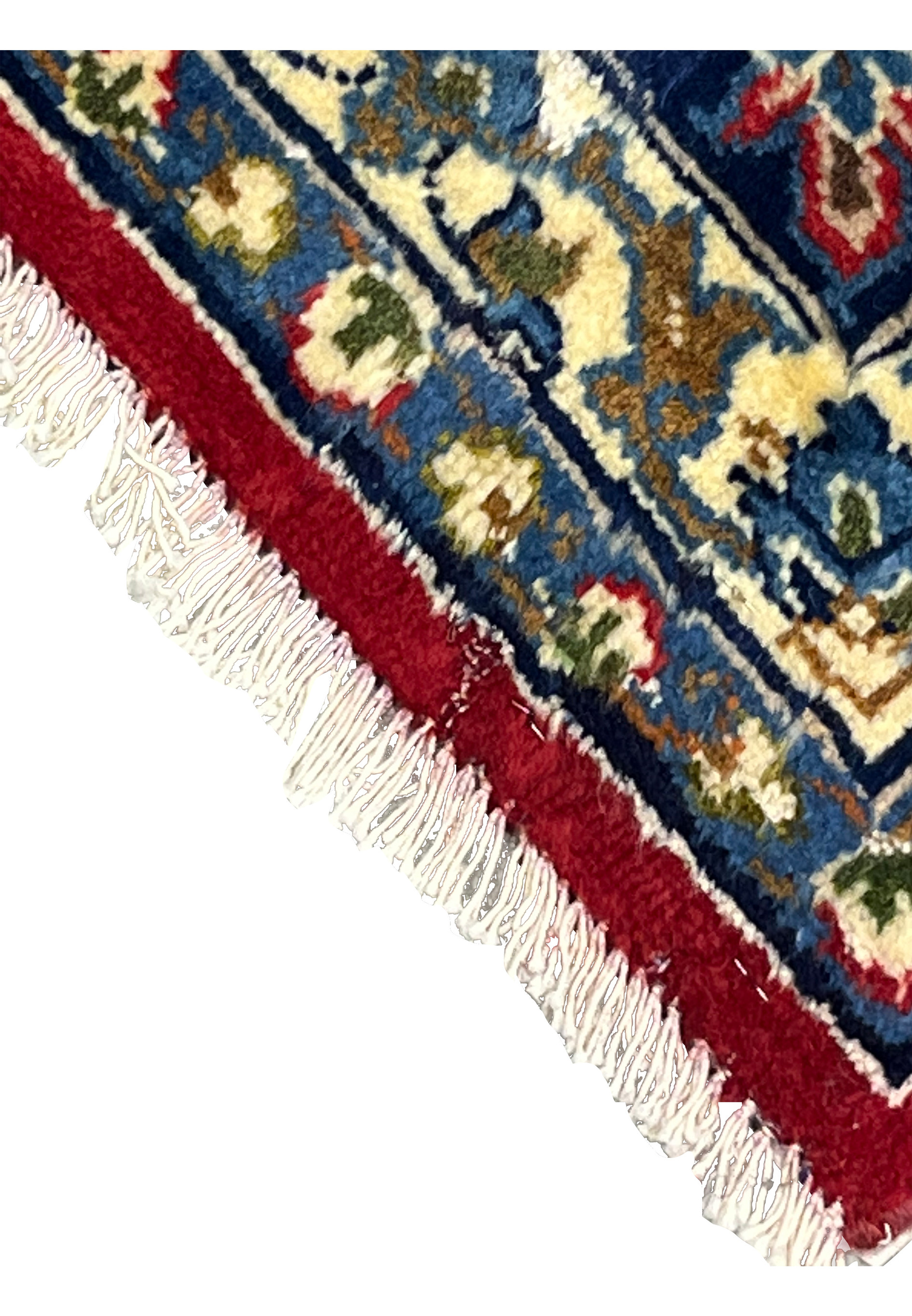 Section of the 8'7 x 12'7 Distressed Persian Isfahan Rug with visible patina and gentle wear, illustrating the rug’s vintage character and softened texture across the red and navy field.