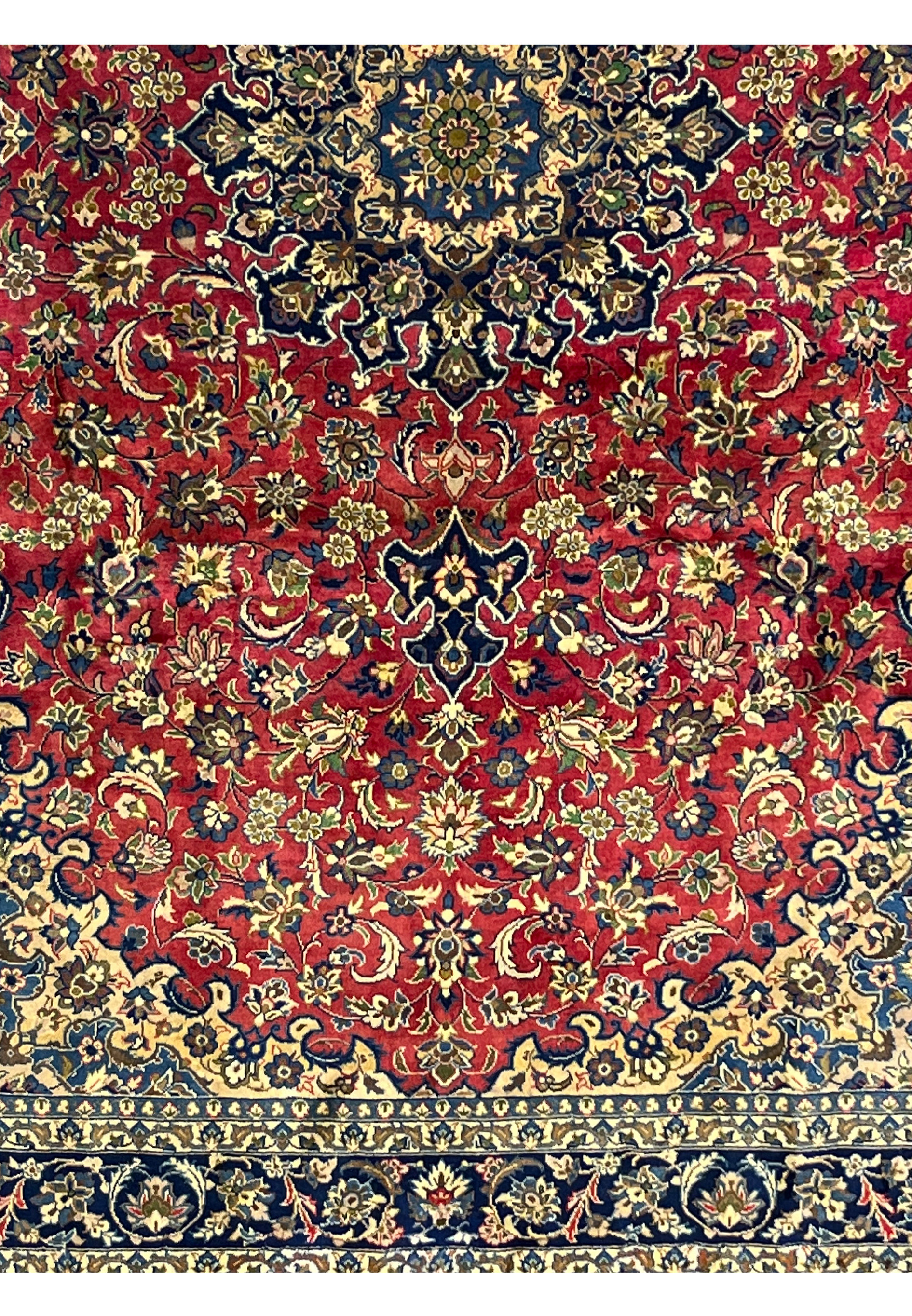 Lower part of the Isfahan Rug displaying navy and ivory floral borders and balanced medallion symmetry.