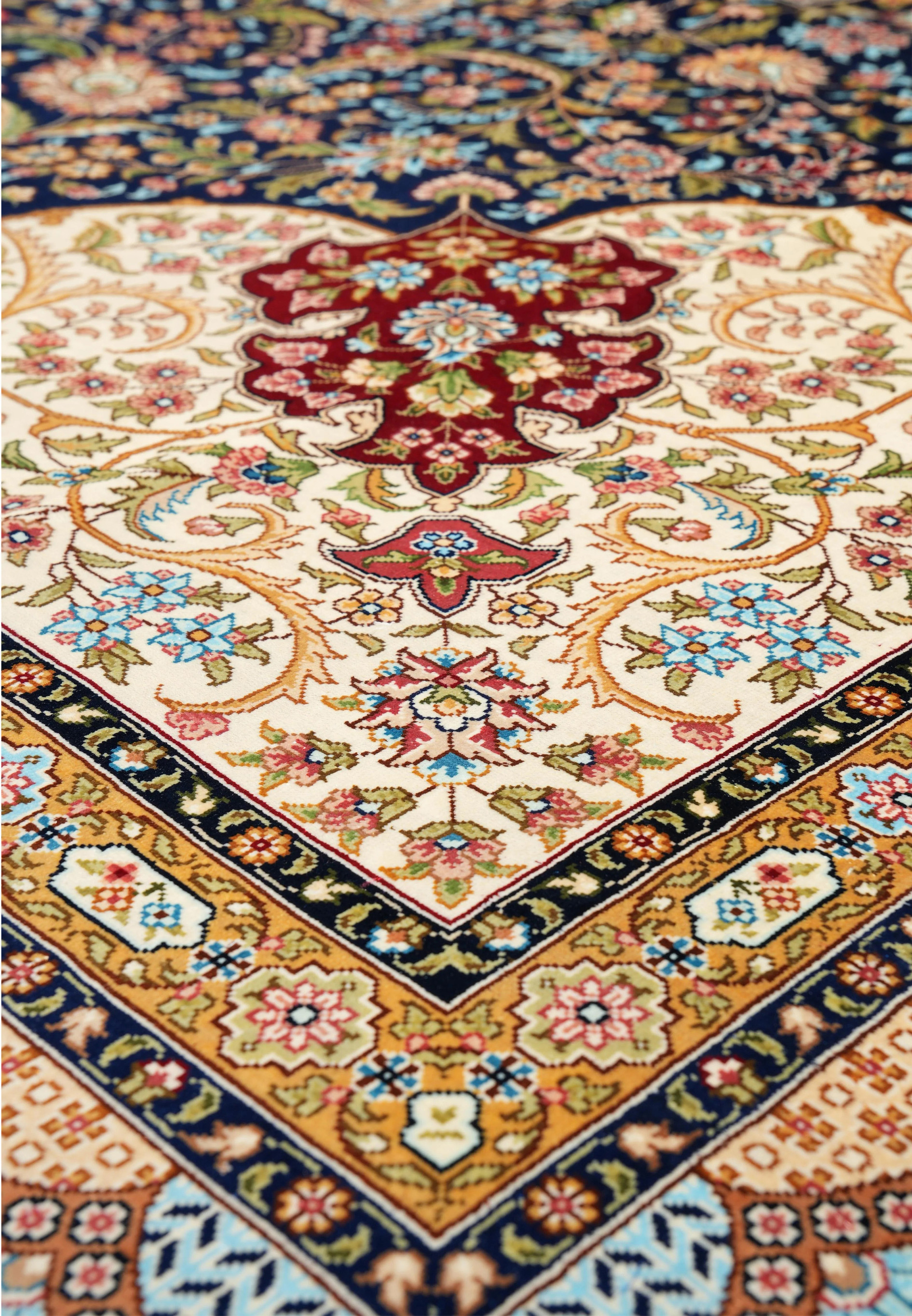 Angled perspective showing the sheen of silk threads and depth of color across the intricate floral design.