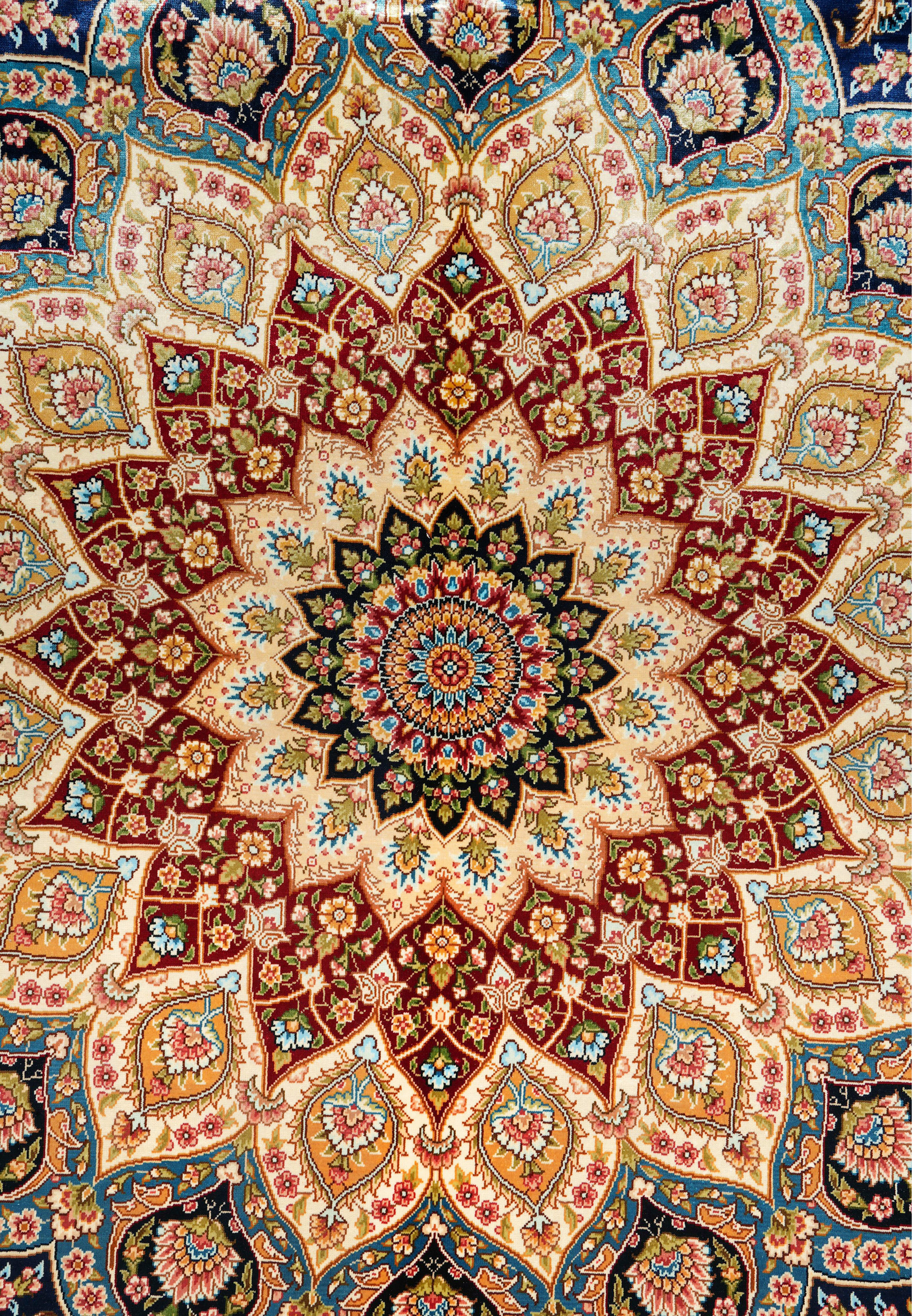 Close-up of the radiant central medallion with lotus and rosette patterns surrounded by ornate vines.