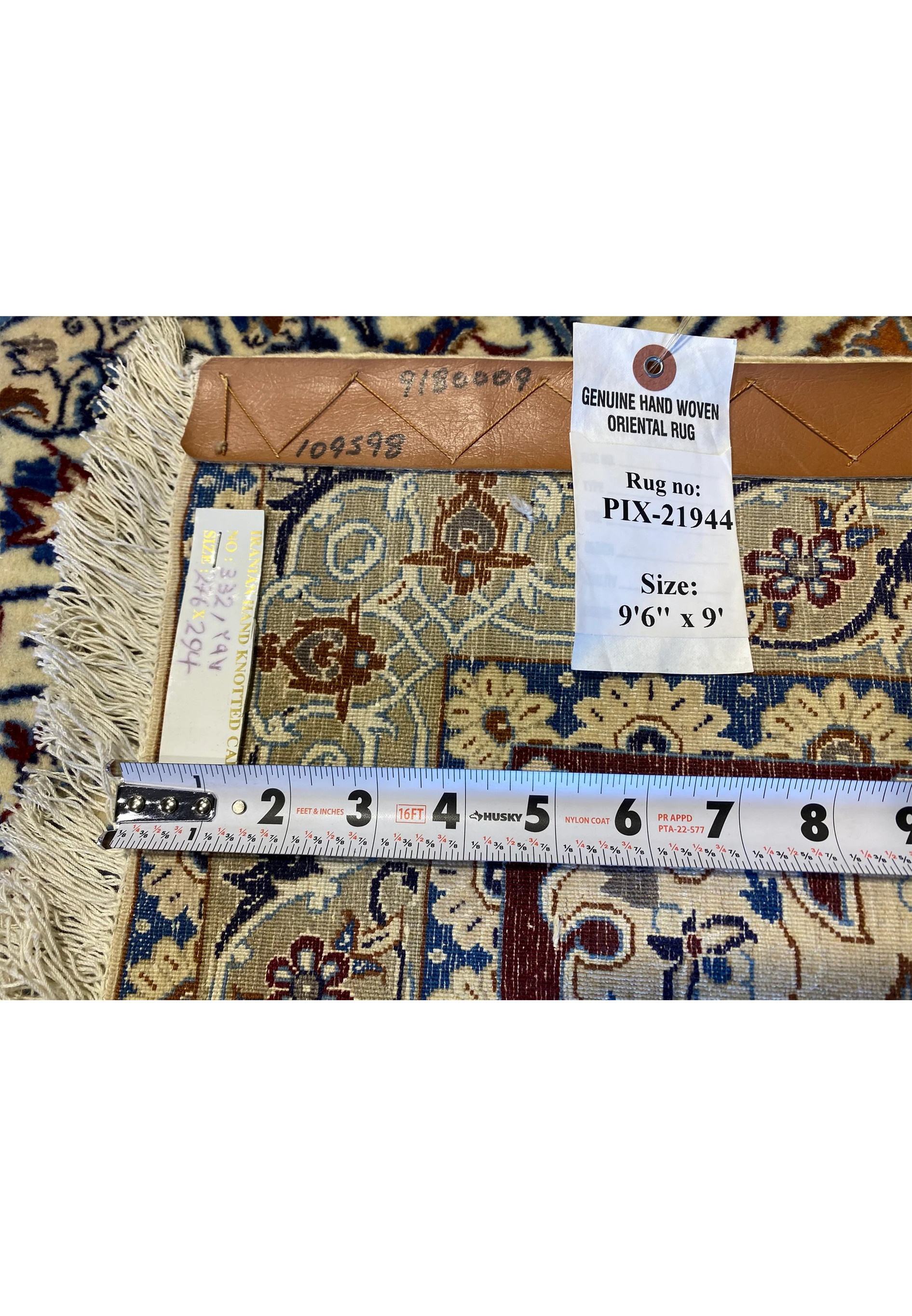 Close-up of the backside of the 9'6" x 9' Persian Nain 6La silk rug showing its fine knot density, original tag with rug number PIX-21944, ruler for scale, and handwoven wool-and-silk structure demonstrating authentic Persian craftsmanship and precision weaving.
