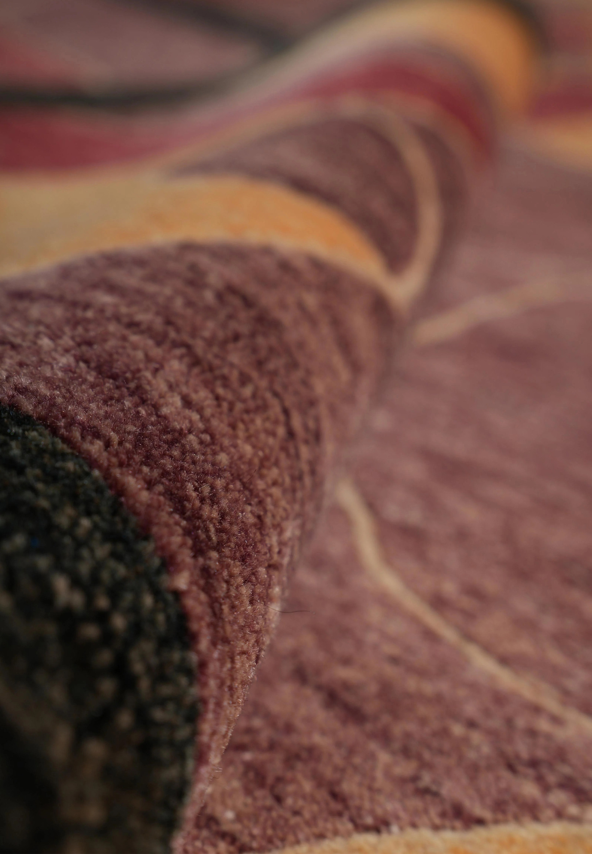 Rolled view of the 8.2 x 10 Tibetan Modern Rug displaying the fine wool texture, color richness, and dense Tibetan weave construction that ensures long-lasting softness and resilience.