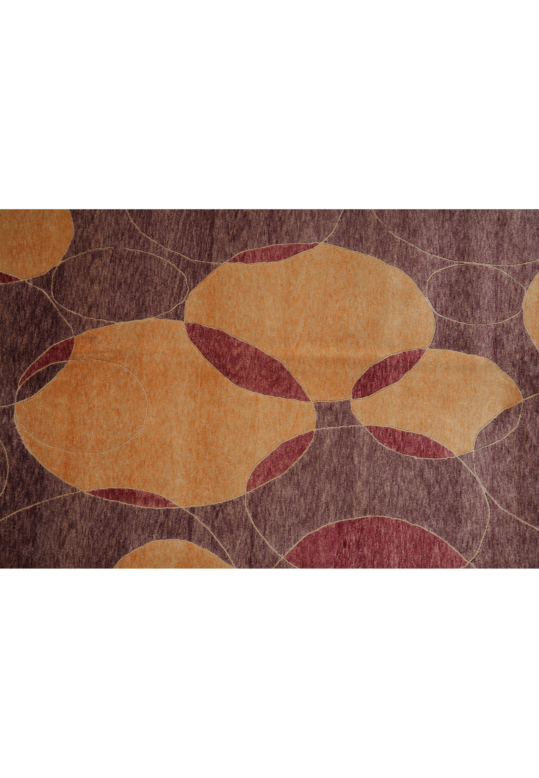 Detailed shot of the rug’s design composition illustrating the balance between warm amber circles and cool plum background tones, highlighting the precision of Tibetan weaving.